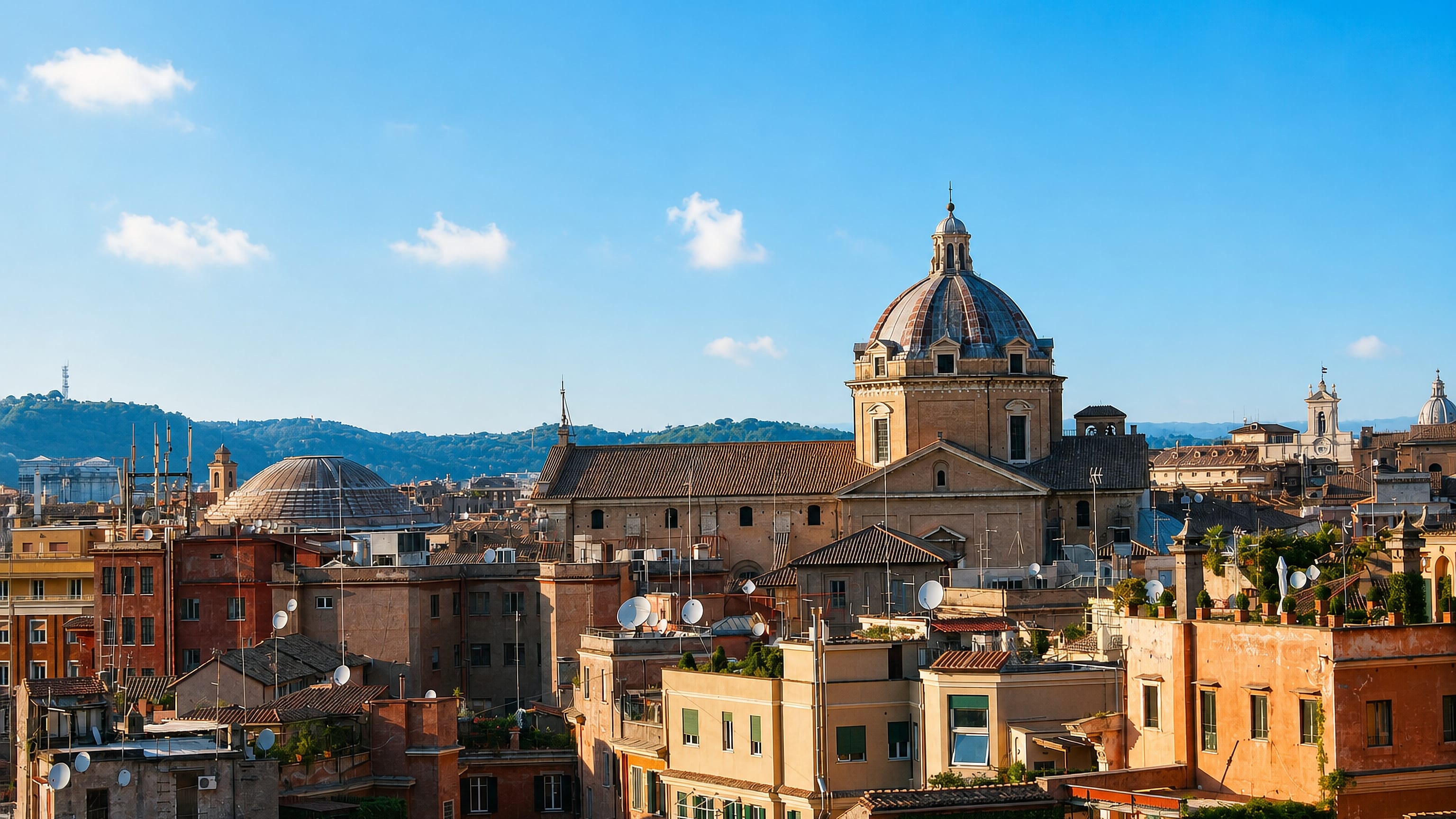 Ochre rooftops of Rome's Pigna rione beneath a large baroque church dome, with green hills on the horizon