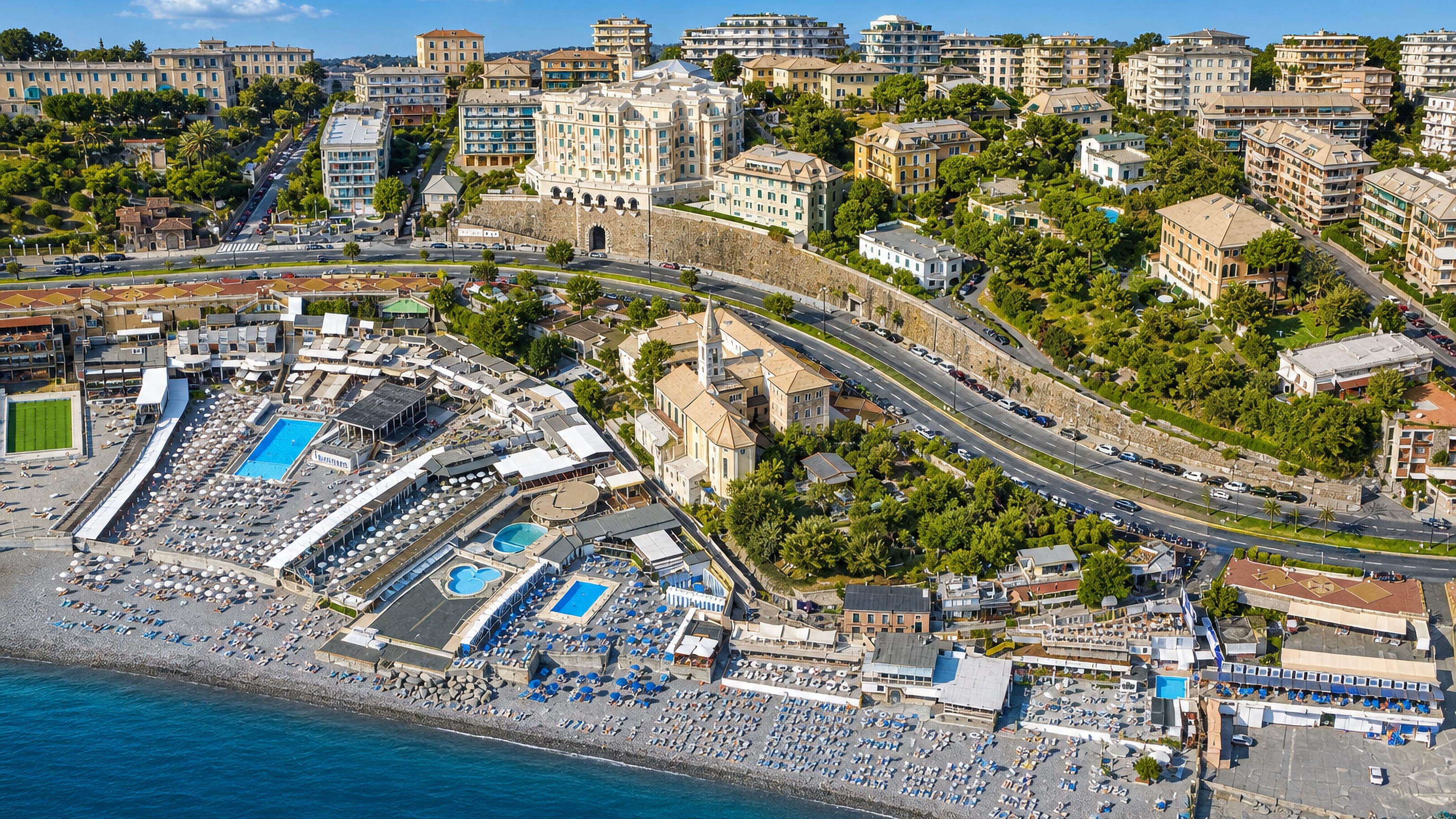 Aerial of the Corso Italia bathing clubs, pools and seaside church along the Albaro shoreline in Genoa.