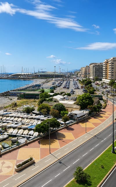 Corso Italia seafront curving past the marina, beach and apartment blocks in Genoa's Foce district