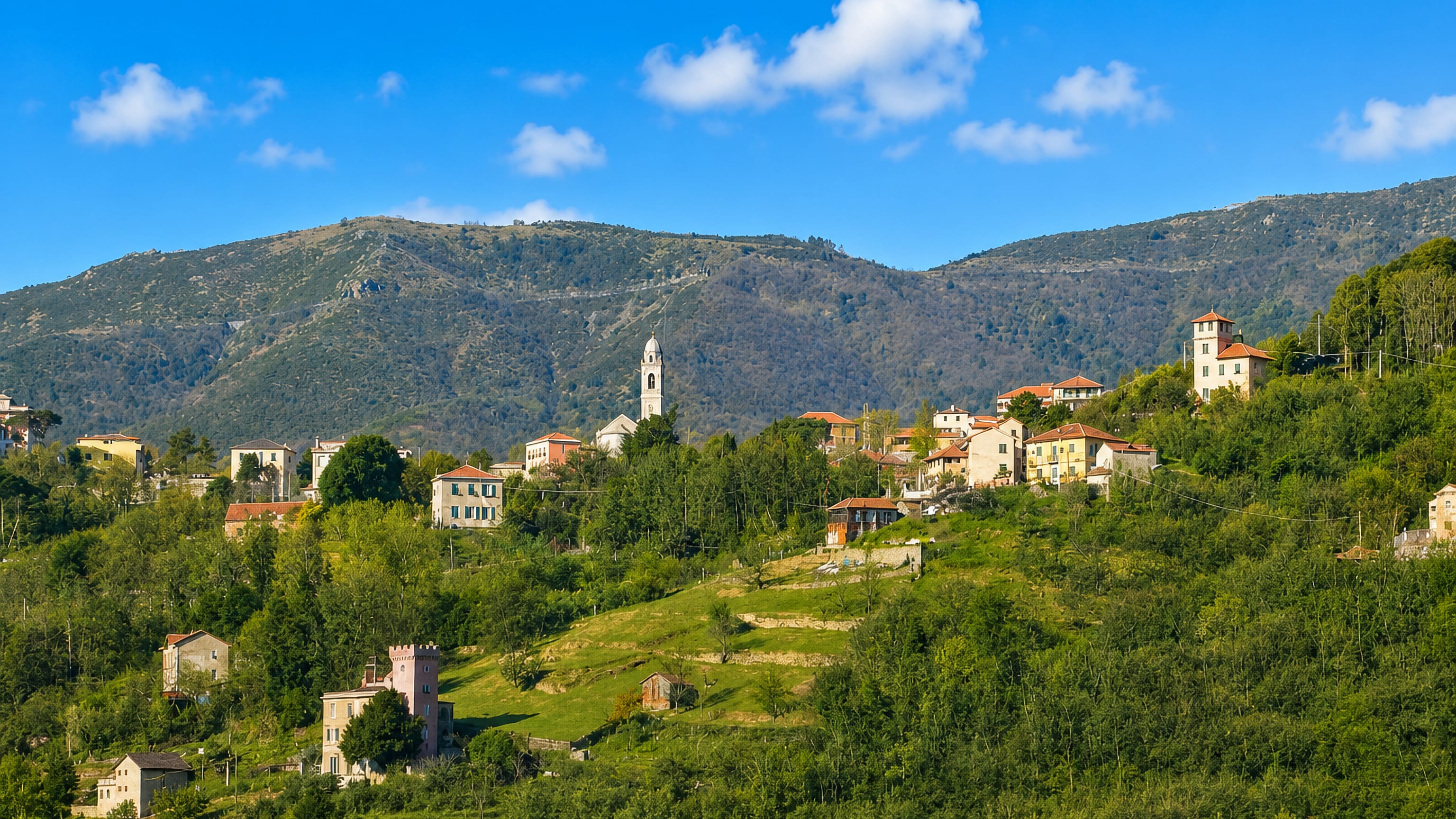 Hillside houses and a white bell tower above terraced fields at Murta in Genoa's Polcevera valley.