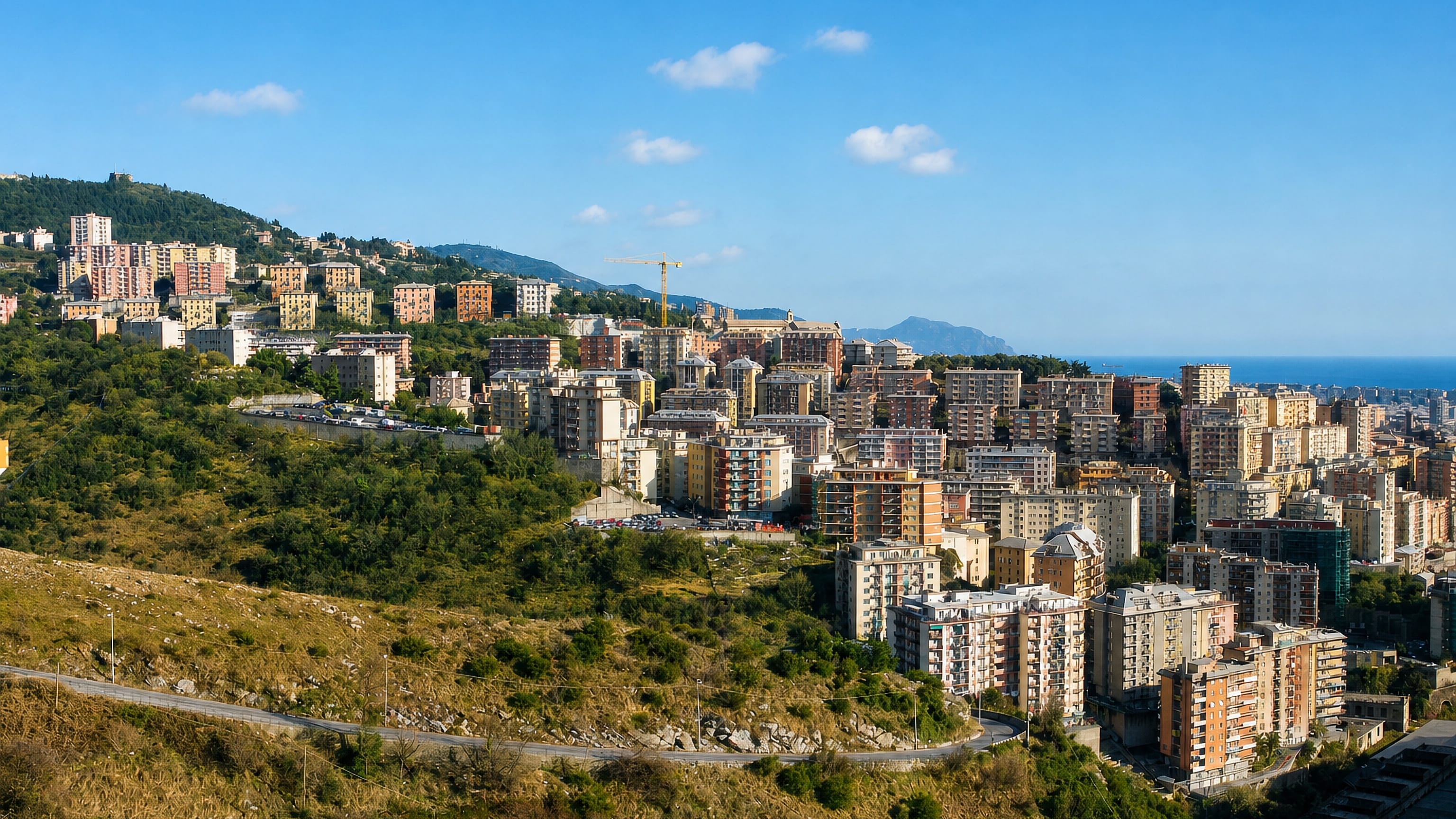 Hillside apartment blocks stepping down towards the sea below the ridge forts in Oregina, Genoa.