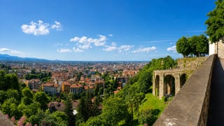 Bergamo's Venetian walls in Città Alta overlooking the terracotta rooftops of the lower town and the Lombard plain