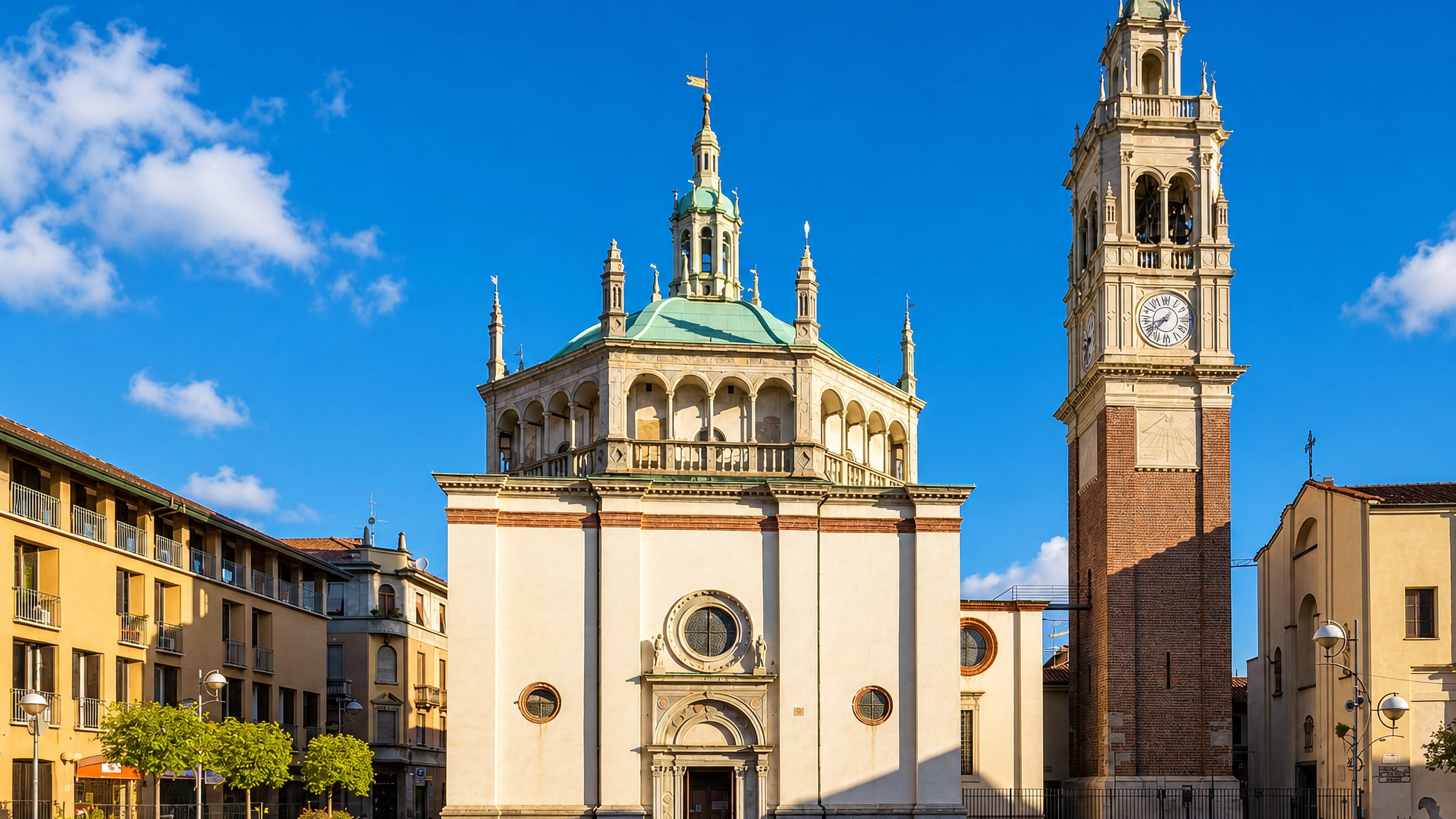 The domed Santa Maria di Piazza sanctuary and its brick bell tower on a sunlit square in Busto Arsizio, Italy.