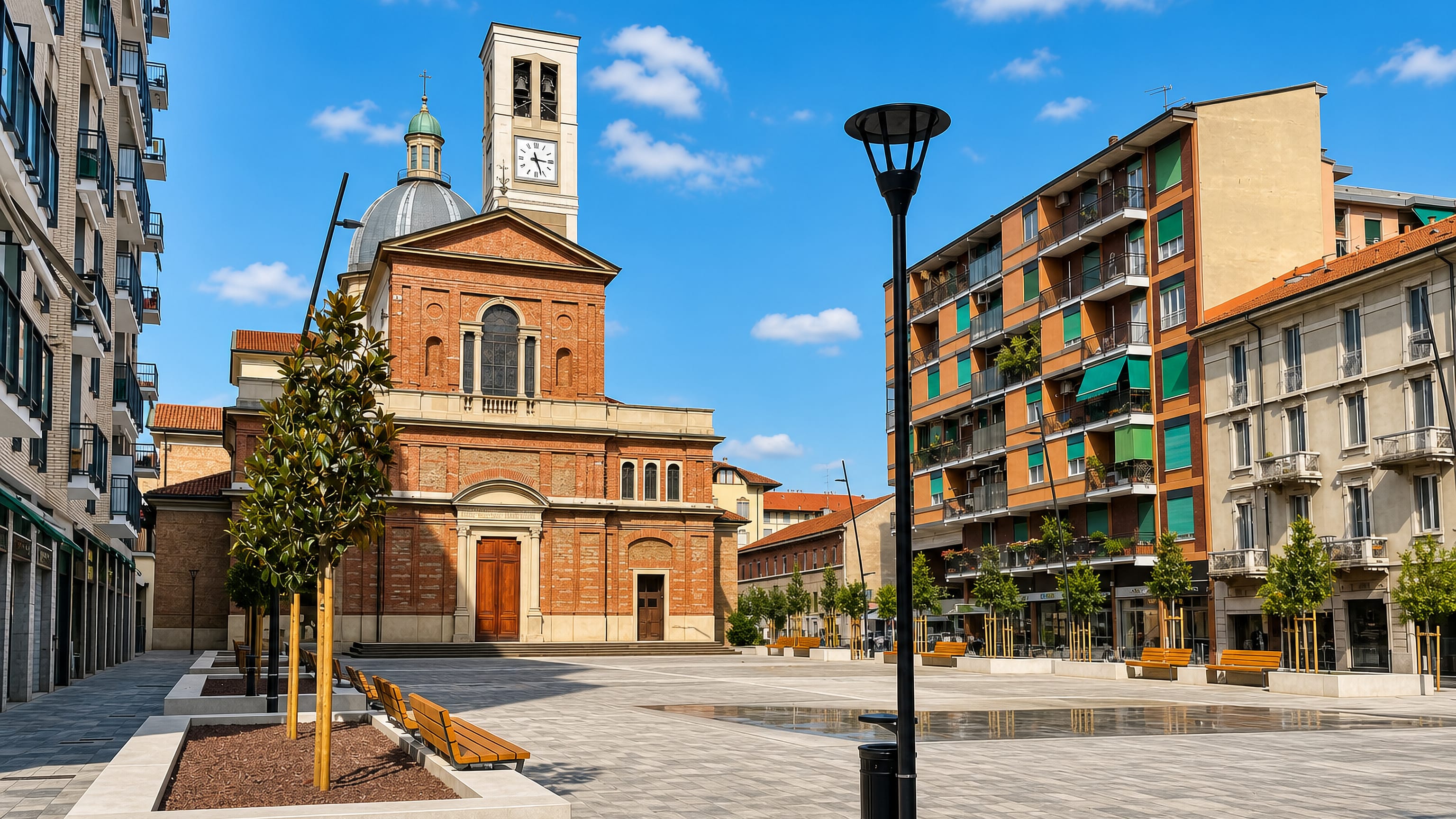 Sesto San Giovanni, Italy: a paved piazza before a brick church with clock tower and dome.