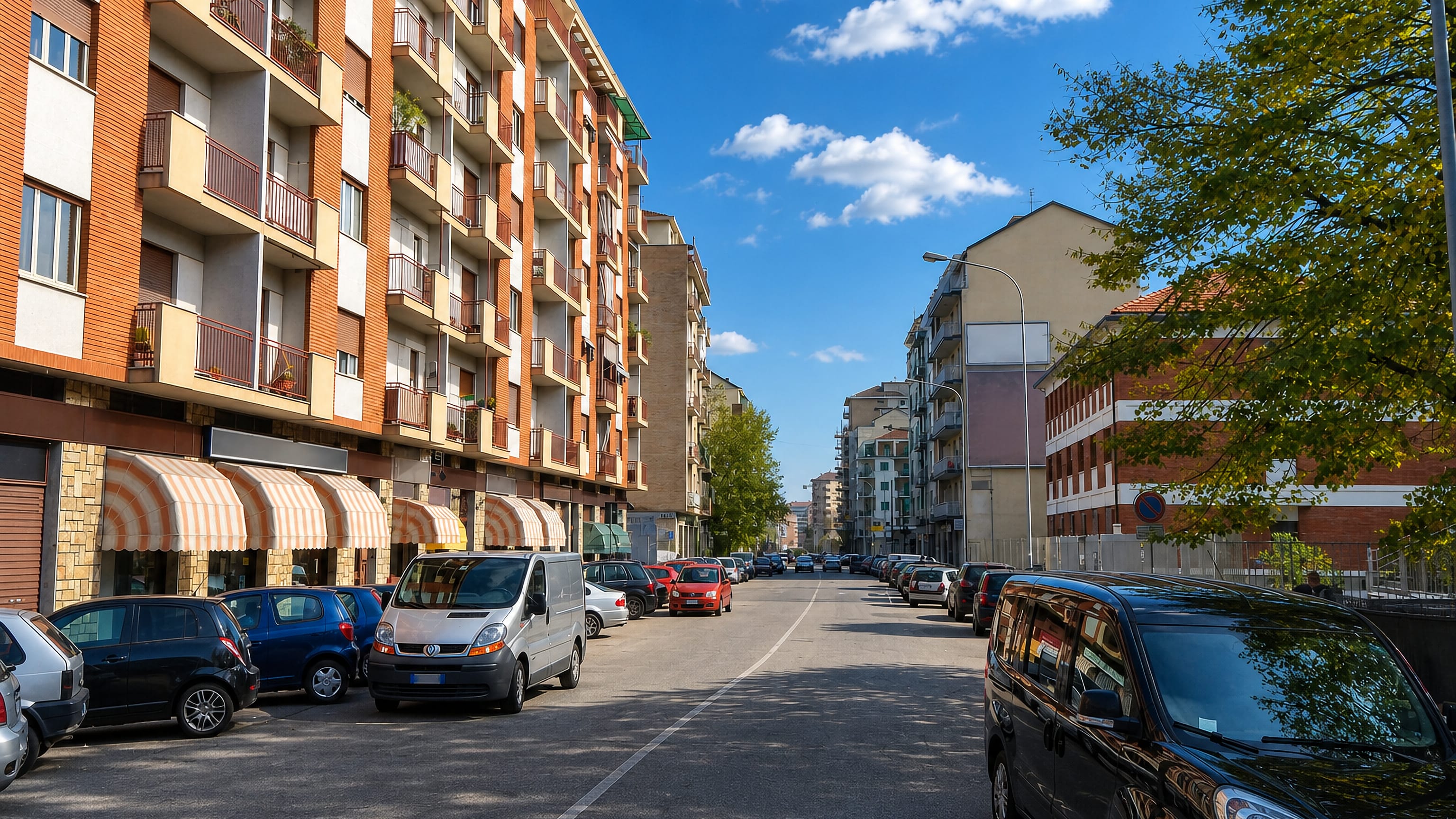 Sunlit residential street in Borgata Lesna, Turin, lined with balconied apartment blocks and parked cars.