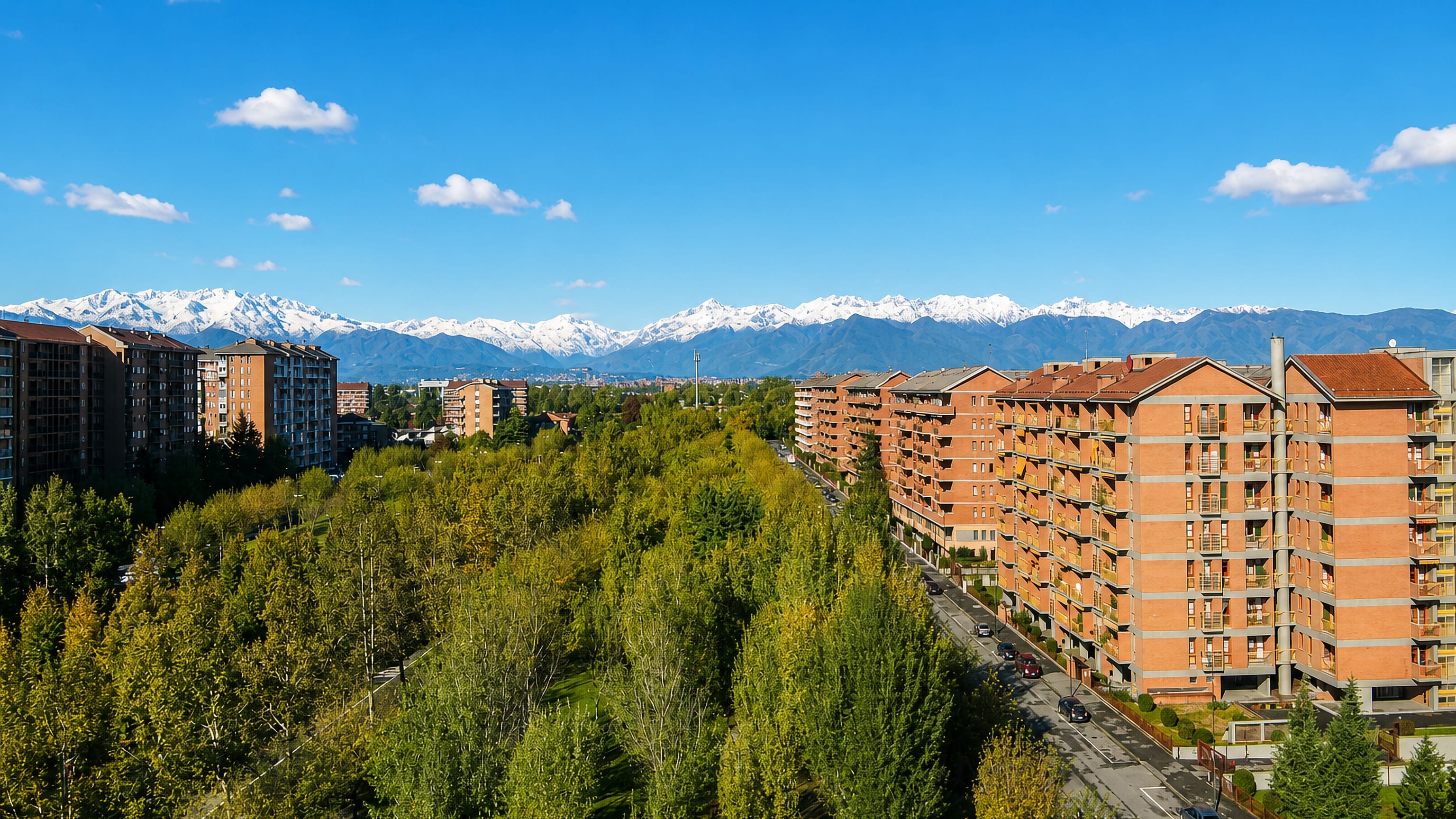 Mirafiori Nord in Turin: red-brick apartment blocks along a tree-lined avenue with the snow-capped Alps beyond.