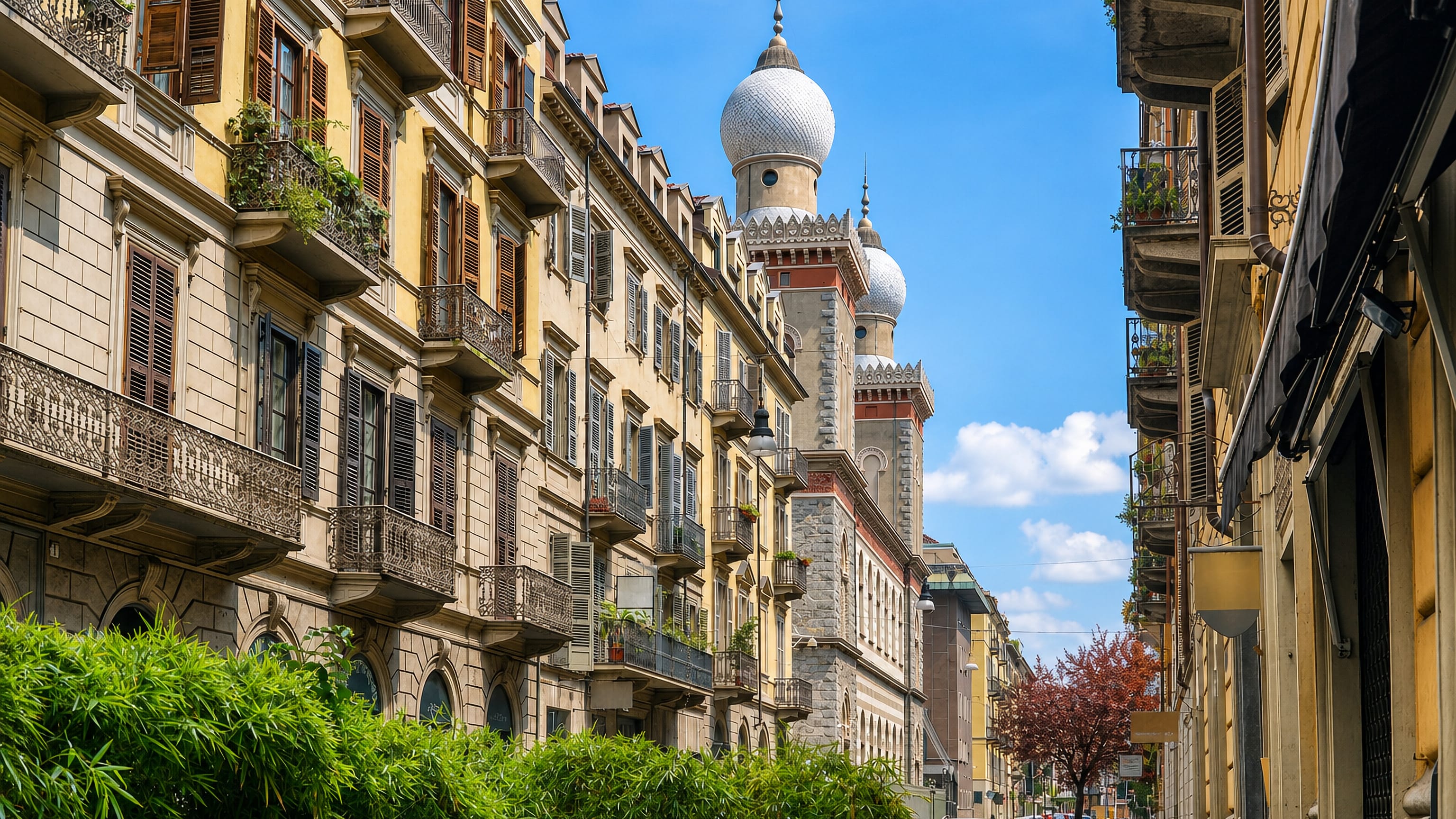 Ornate balconied facades on a San Salvario street in Turin, leading to the synagogue's onion domes
