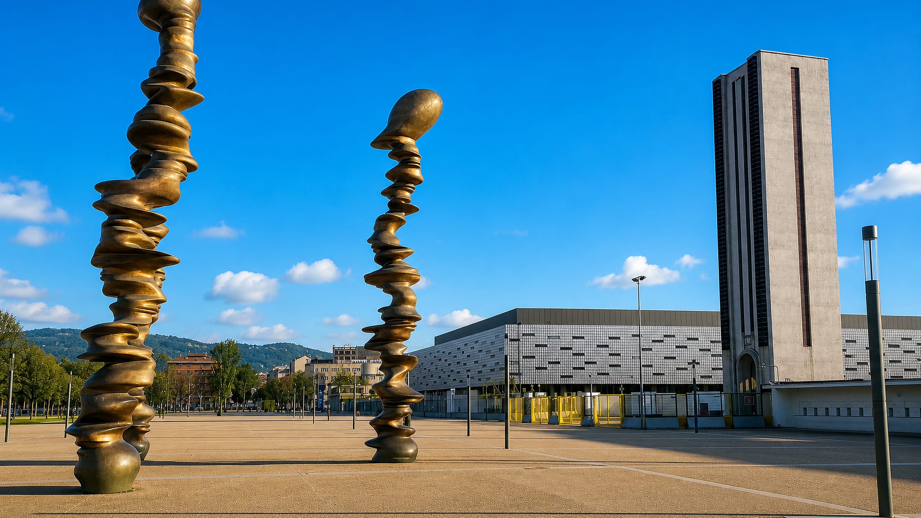 Bronze sculptures on the plaza before the Palasport Olimpico and stadium tower in Santa Rita, Turin.