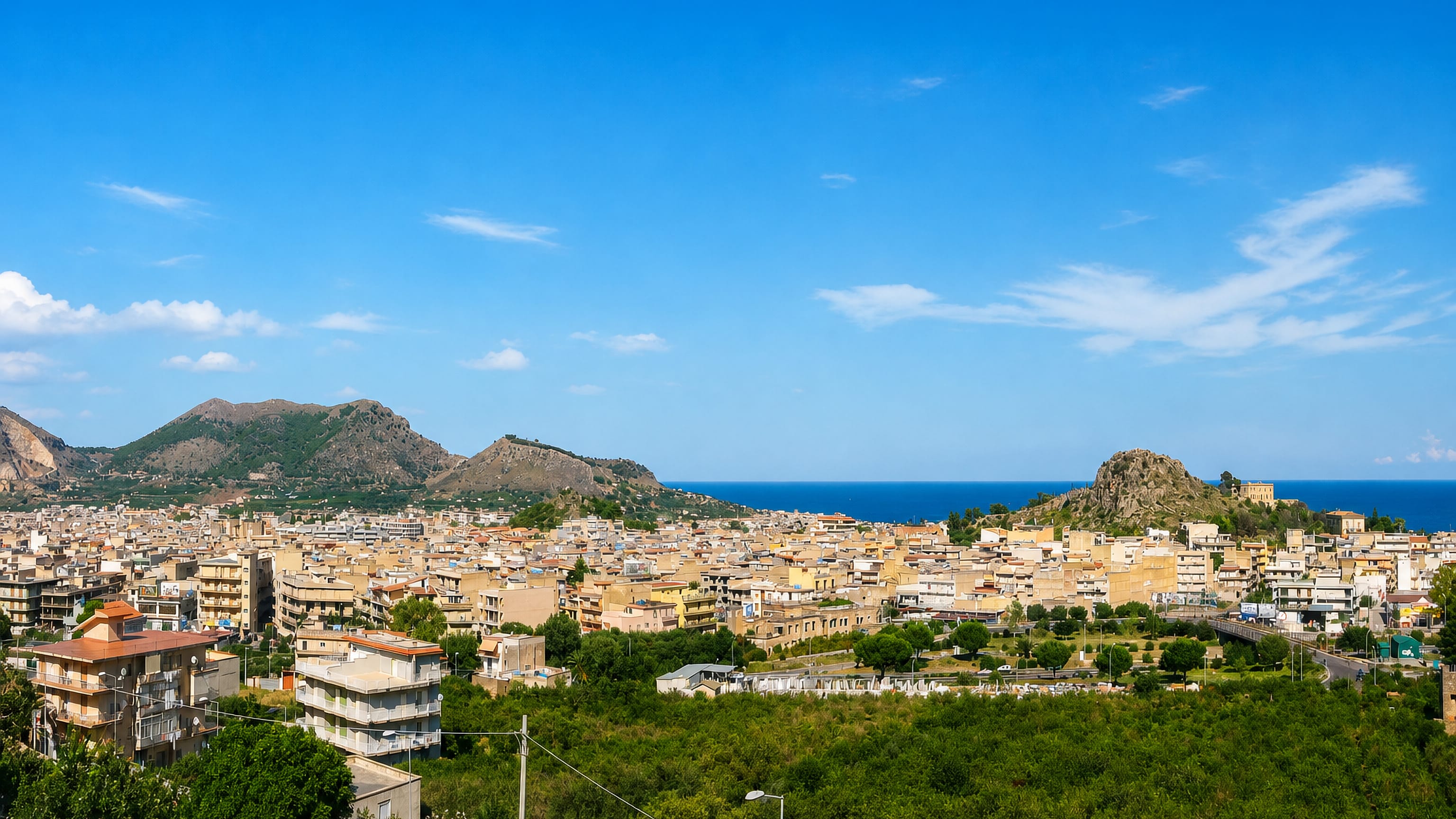 Bagheria's ochre houses spread between citrus groves, coastal hills and the Tyrrhenian Sea in Sicily