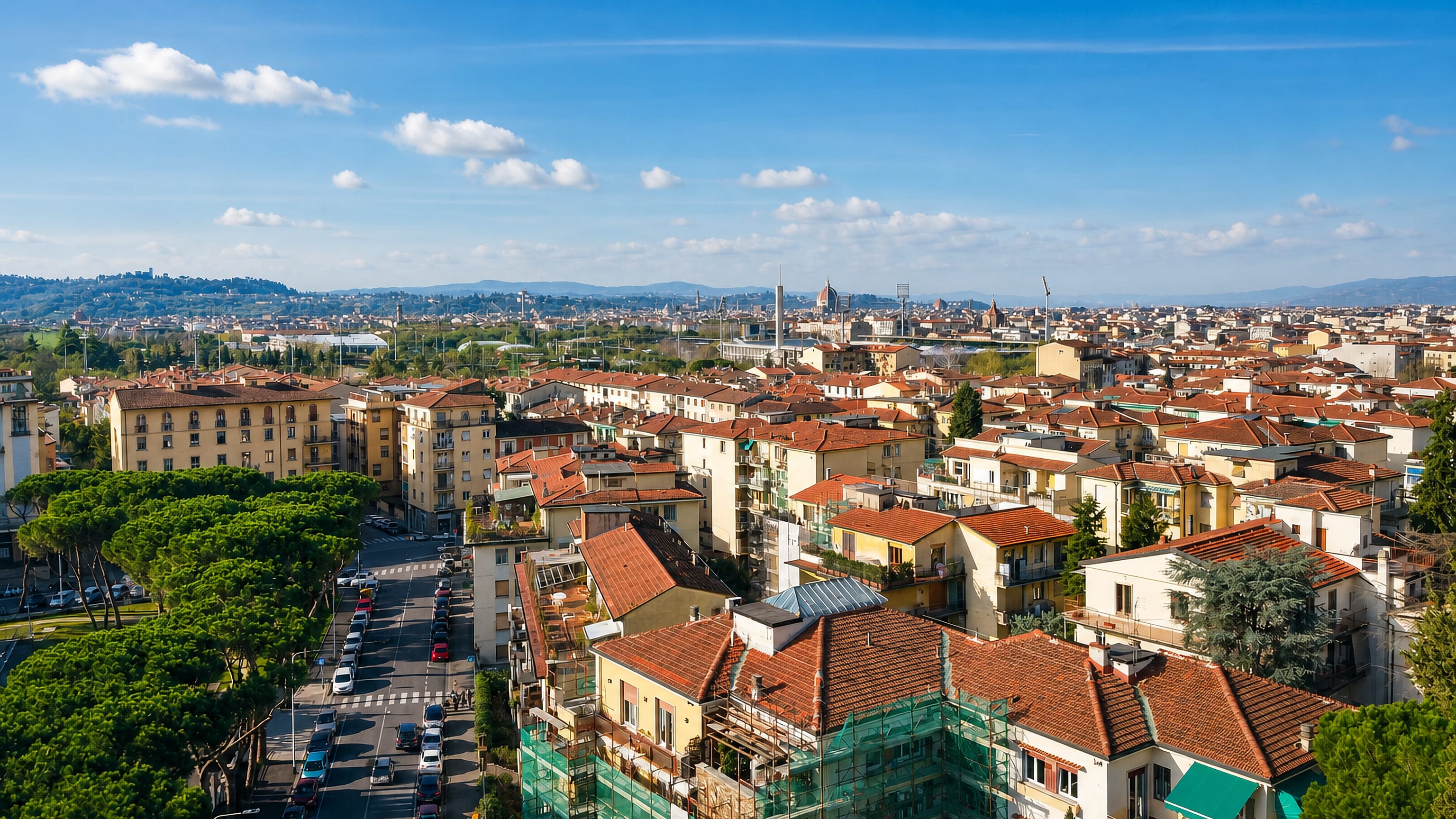 Rooftops of Campo di Marte with Florence's Duomo, towers and stadium floodlights on the skyline beyond.