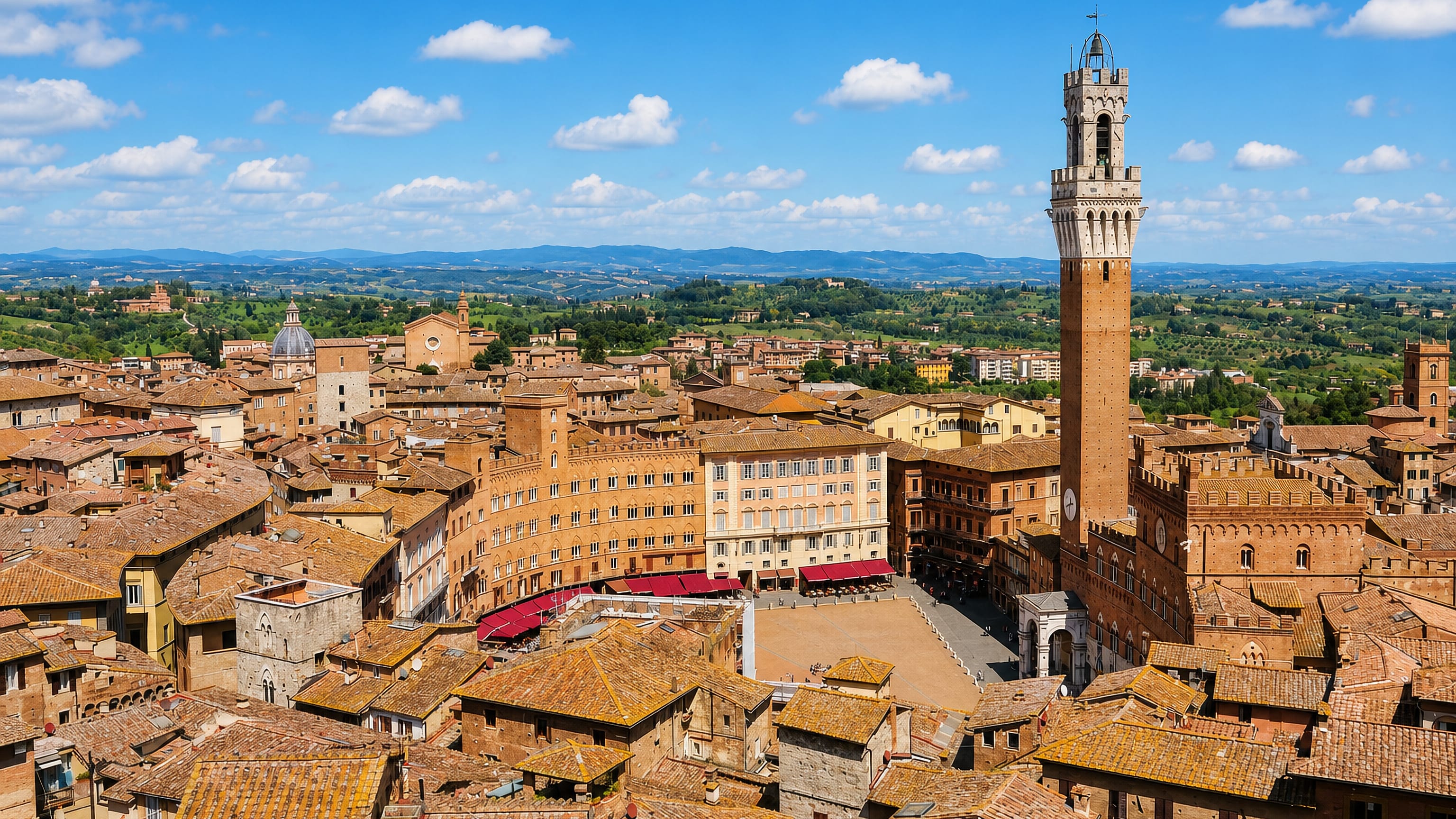 Siena's Piazza del Campo and the Torre del Mangia rising above terracotta rooftops and the Tuscan hills
