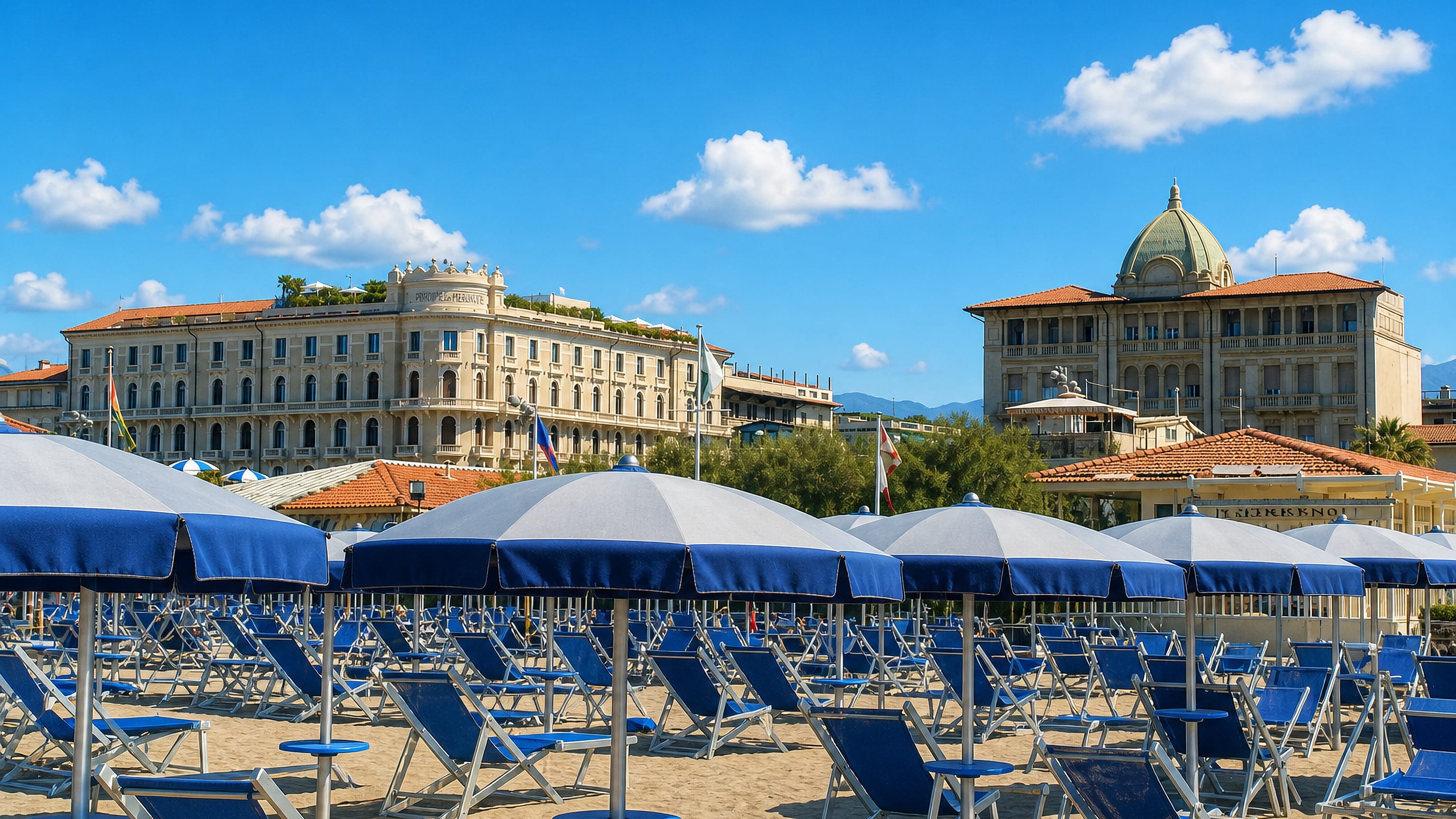 Blue-and-white beach umbrellas on Viareggio's sand below the Liberty-style hotels of the Tuscan seafront.