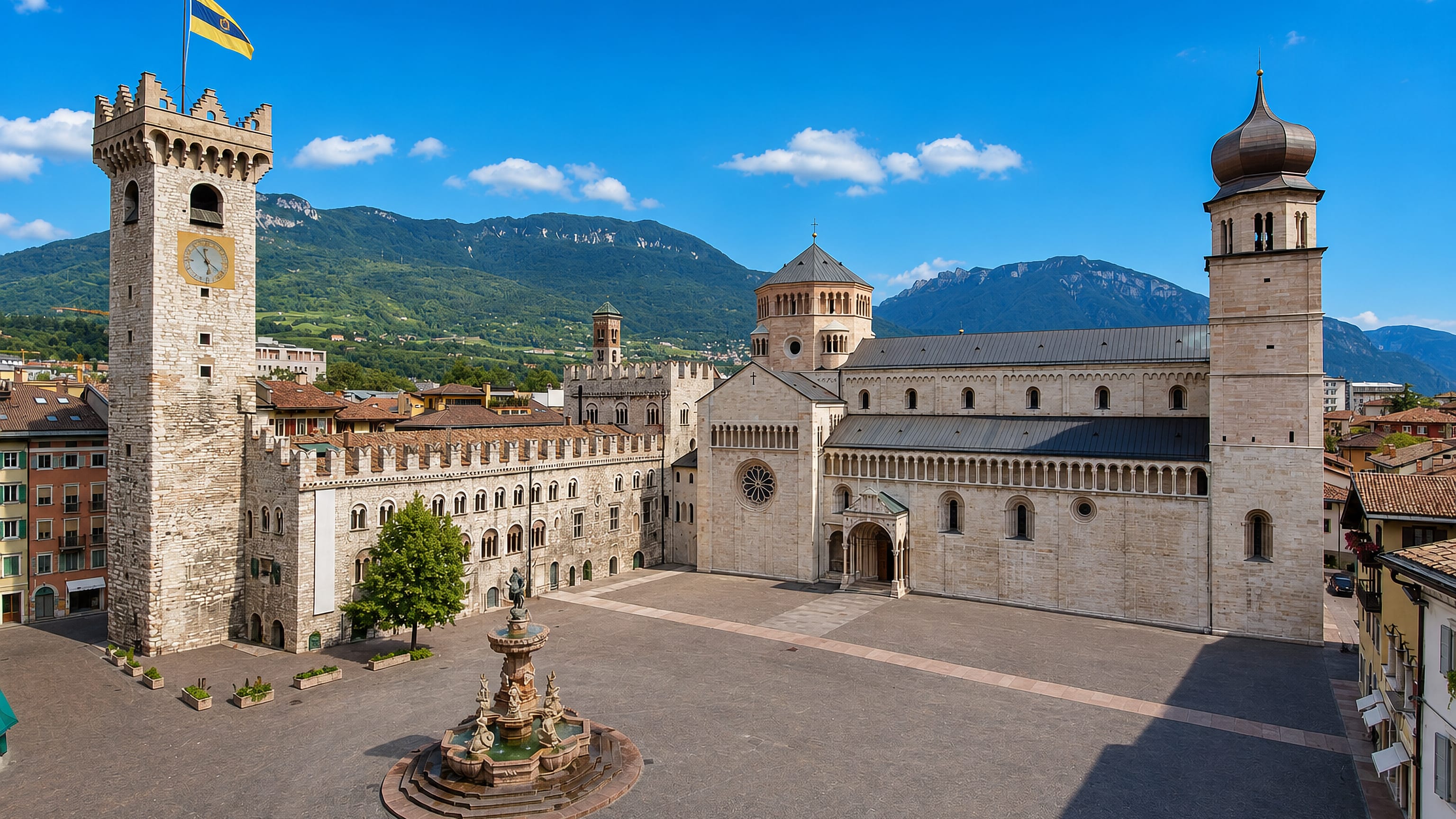 Piazza Duomo in Trento, Italy, with the Torre Civica, Neptune fountain and San Vigilio cathedral below Alpine slopes.