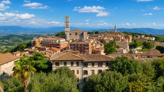 Perugia's hilltop old town in Umbria, the San Domenico bell tower rising above terracotta roofs and the valley