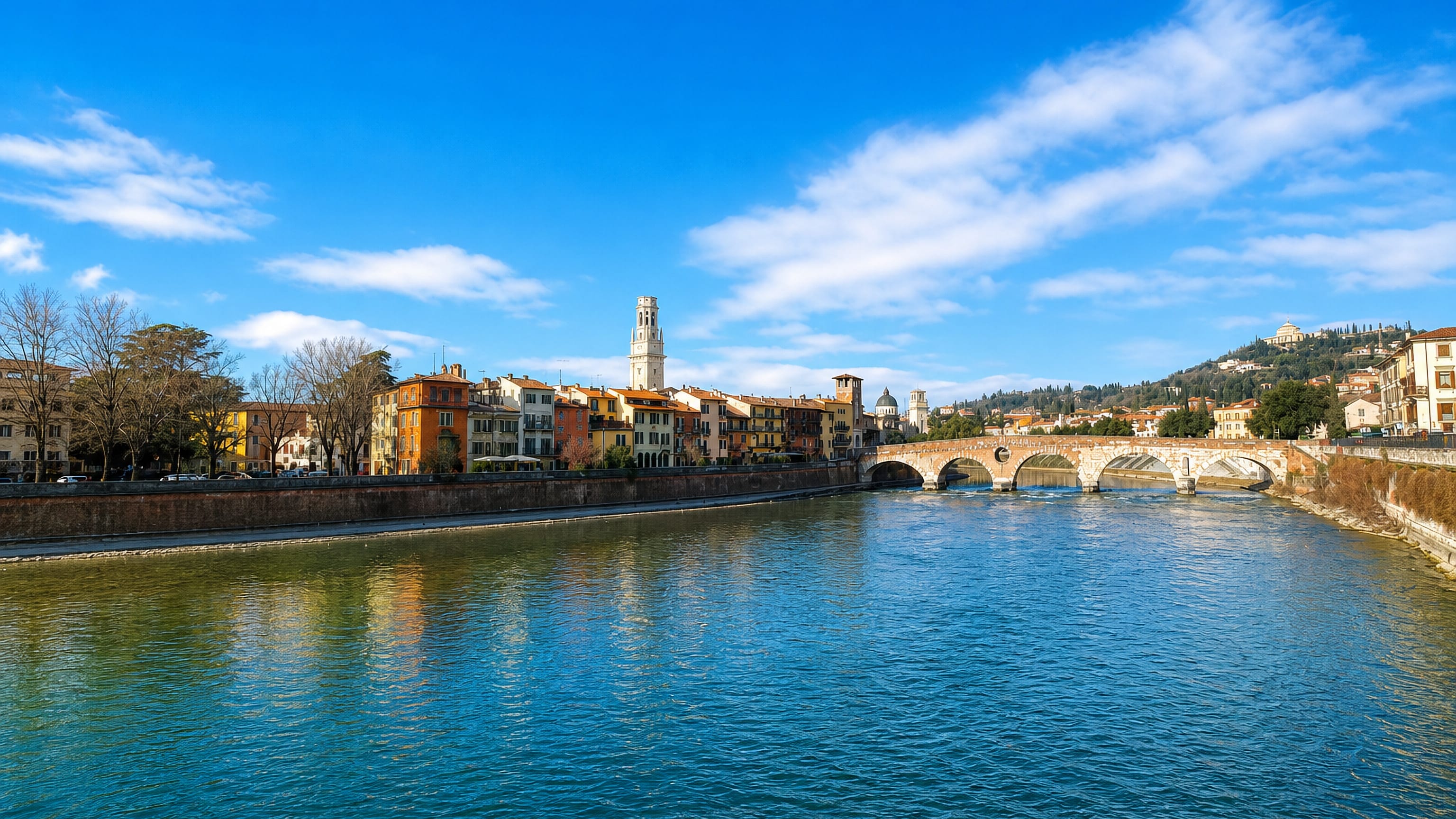 Verona's Roman Ponte Pietra spanning the Adige, with the Duomo bell tower above the riverside houses