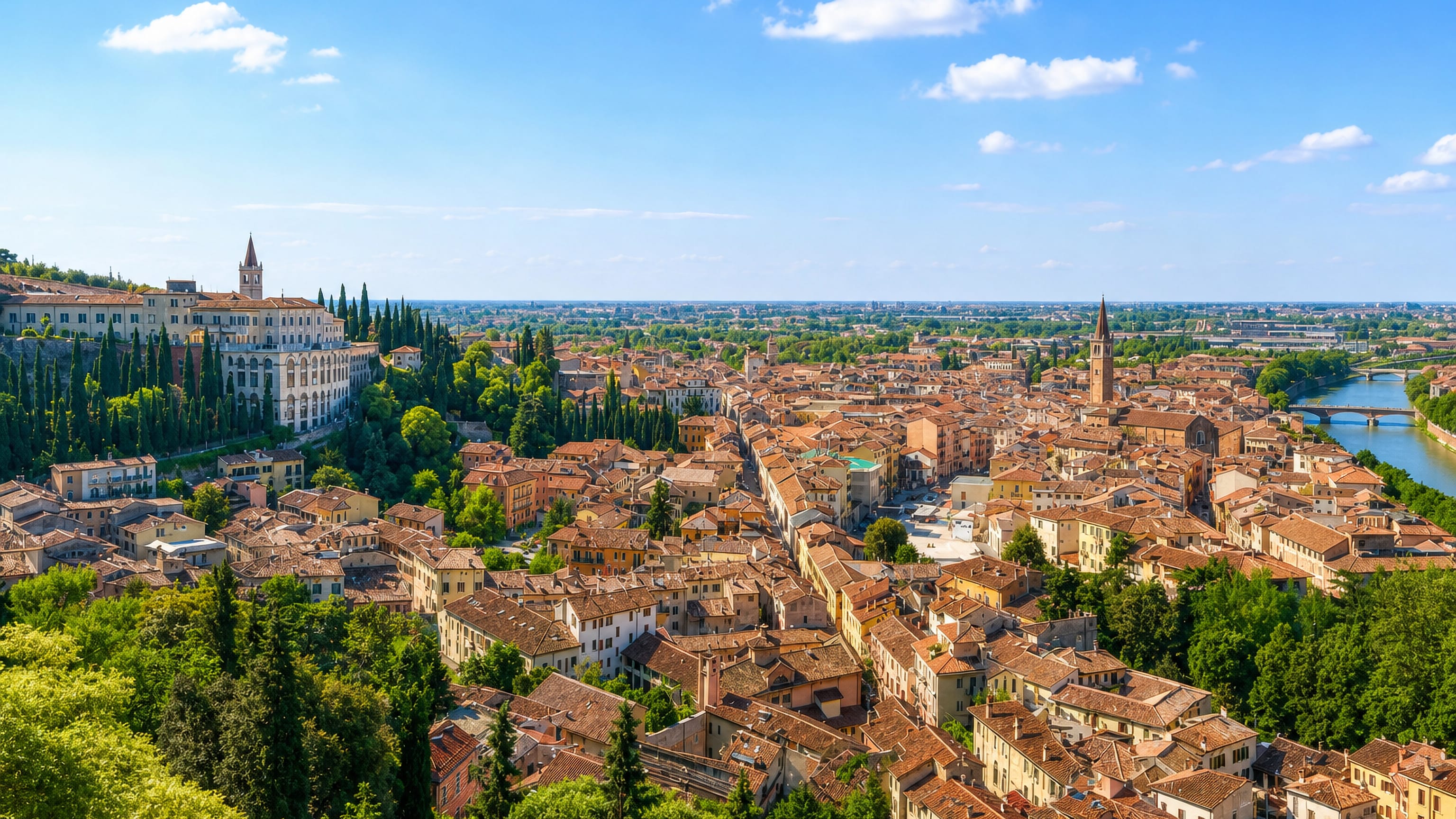 Rooftops of Veronetta below San Pietro hill in Verona, with the Adige river and church bell towers.