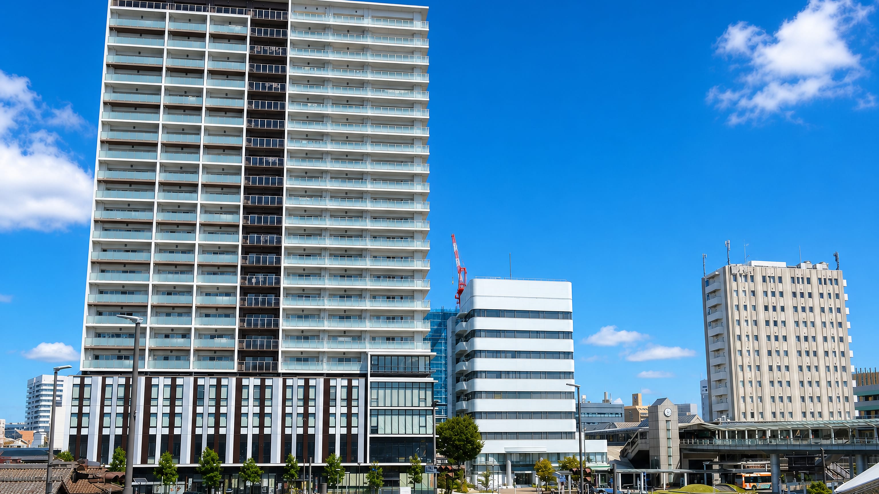 High-rise apartment tower and pedestrian deck at the station front in Kariya, Aichi Prefecture, Japan.