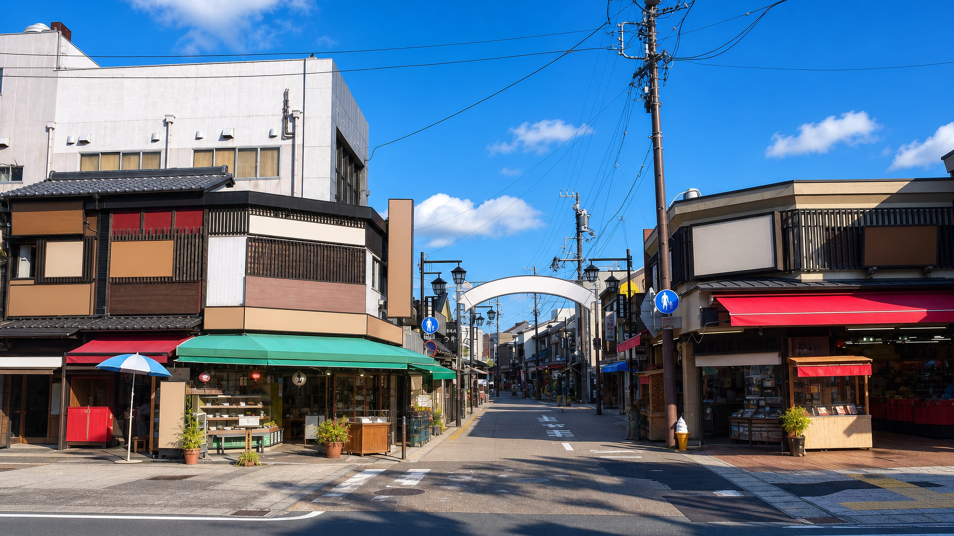 Traditional shopfronts and an arched gate along the temple approach street in Toyokawa, Japan.