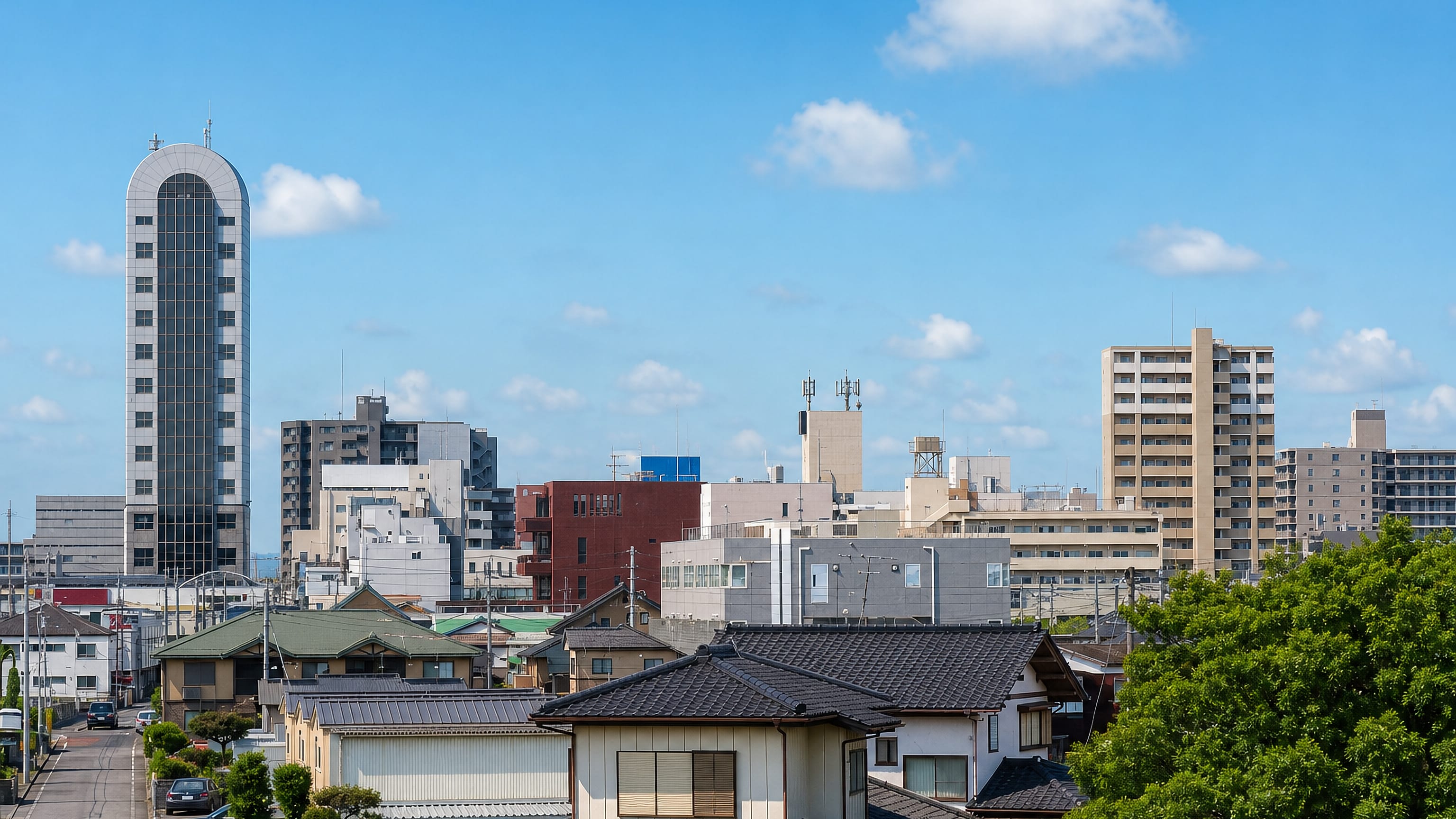 Ichihara, Chiba, with tiled-roof houses in front of mid-rise blocks and a curved-top tower
