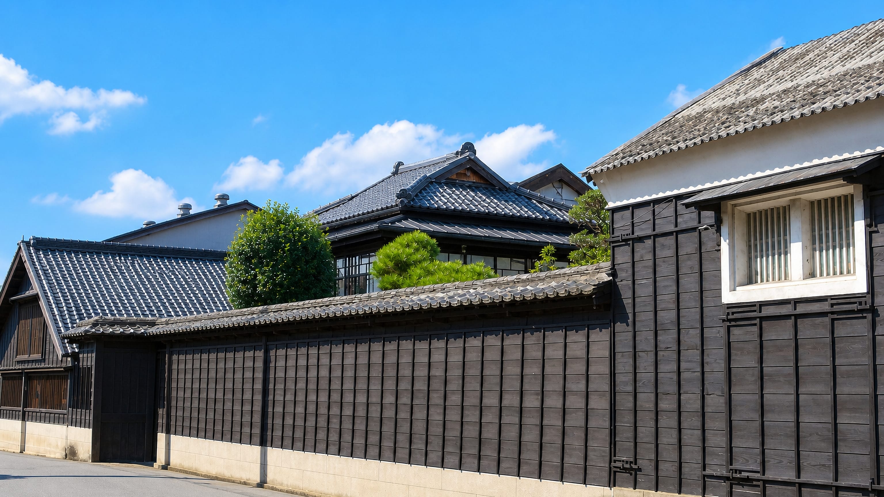 Black timber walls and tiled roofs of a historic brewery merchant quarter in Noda, Chiba Prefecture, Japan.