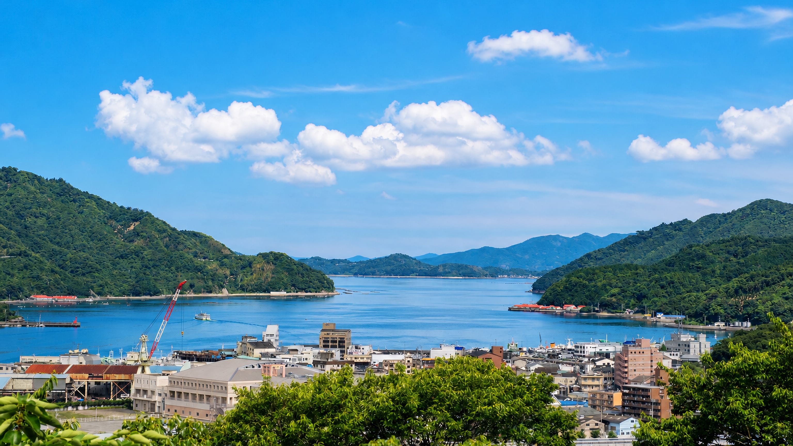 Uwajima, Japan, its harbour and town wrapped by the green hills of a sheltered ria bay.