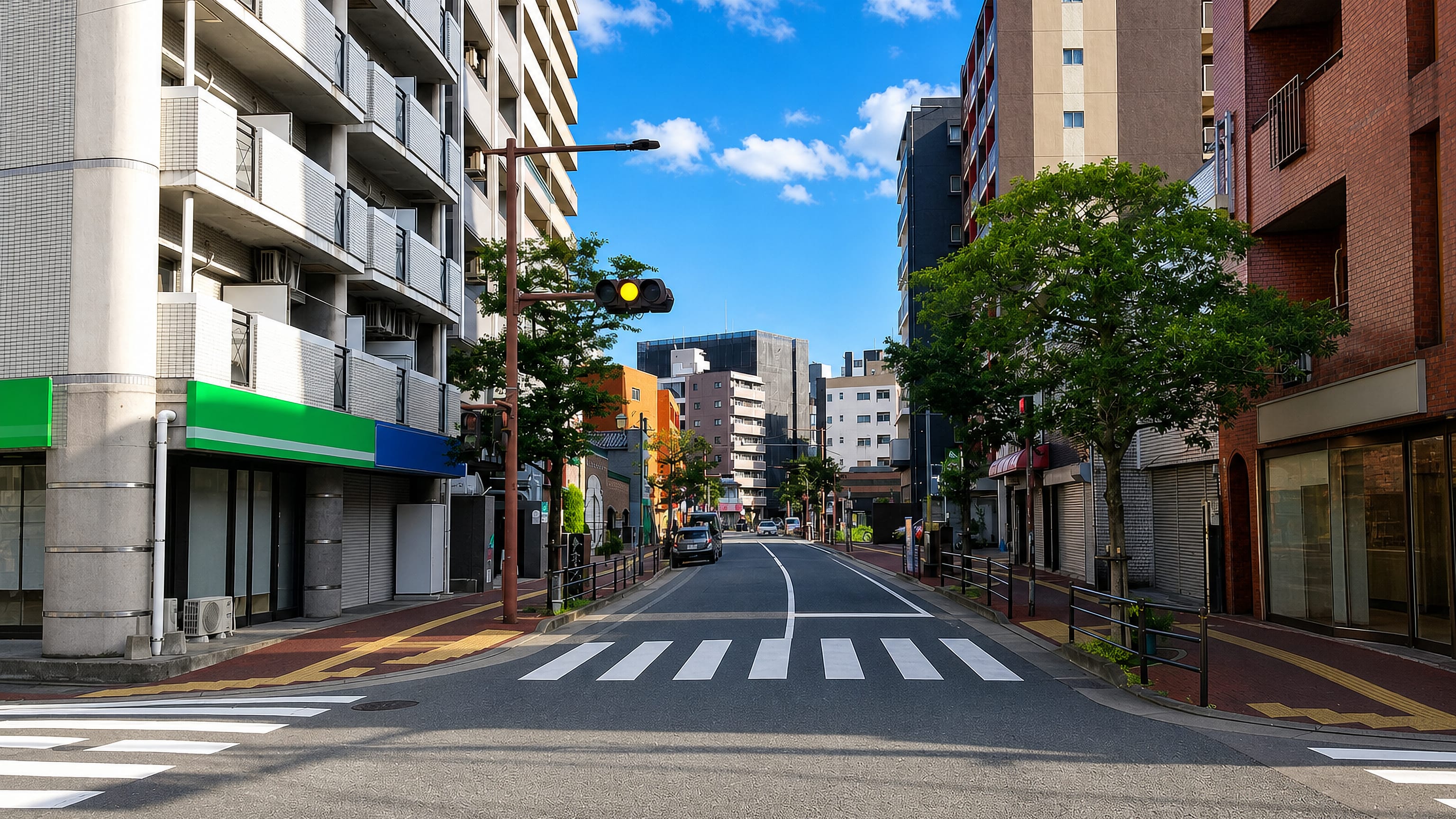 Quiet street of apartment blocks and shuttered shopfronts in Arato, central Fukuoka.