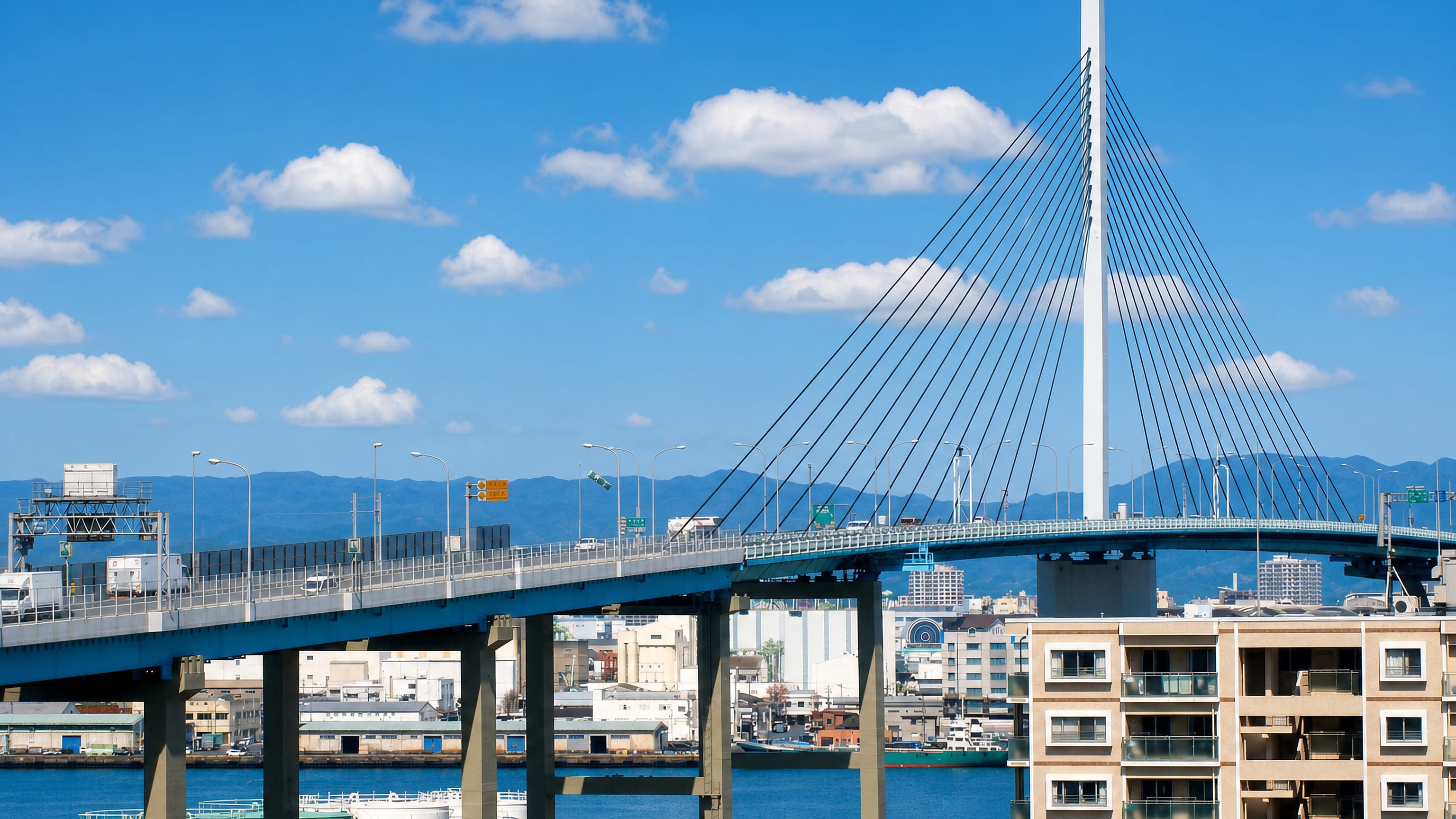 The cable-stayed Aratsu bridge and elevated expressway curving over Hakata Bay in Aratsu, Fukuoka.