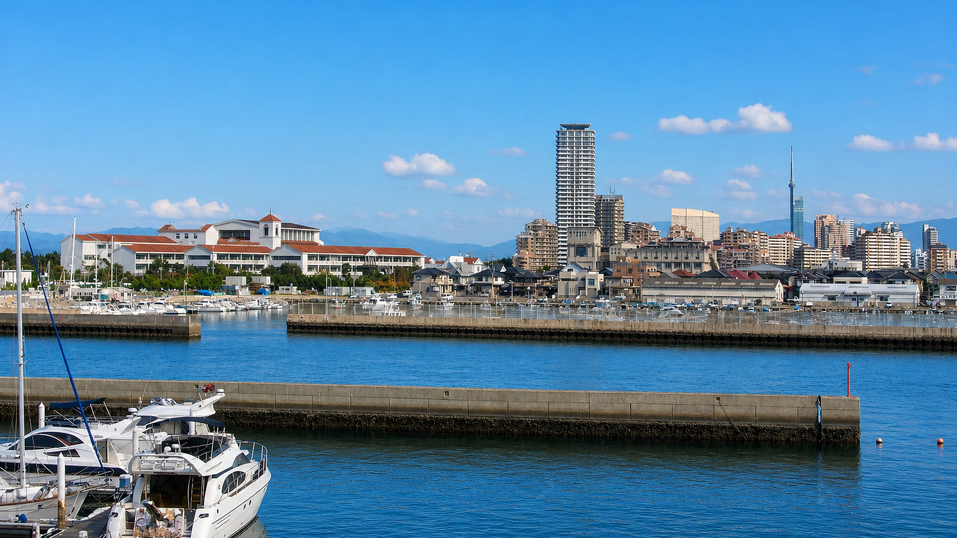 Fukuoka Tower and waterfront high-rises seen across the marina at Atago-hama, Fukuoka.