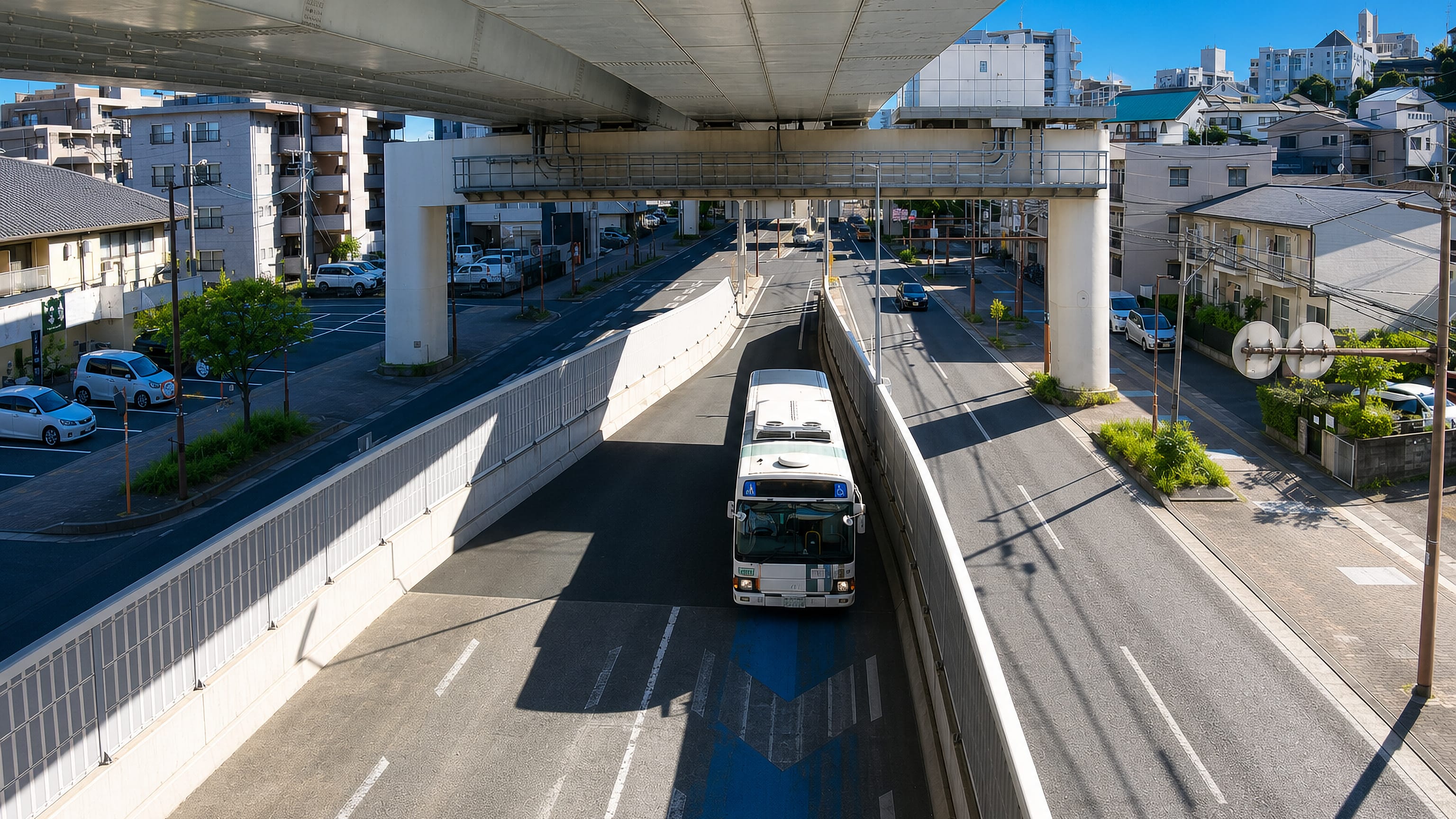 Elevated expressway above a sunken roadway and bus in the residential district of Atago, Fukuoka