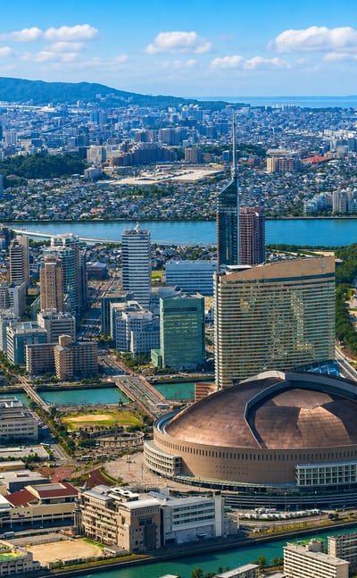 Aerial view of Fukuoka's Momochi waterfront with its domed stadium, seafront hotel tower and beach