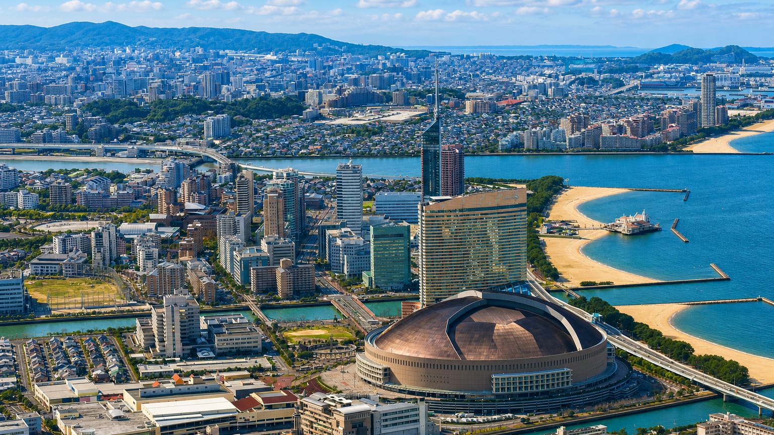 Aerial view of Fukuoka's Momochi waterfront with its domed stadium, seafront hotel tower and beach