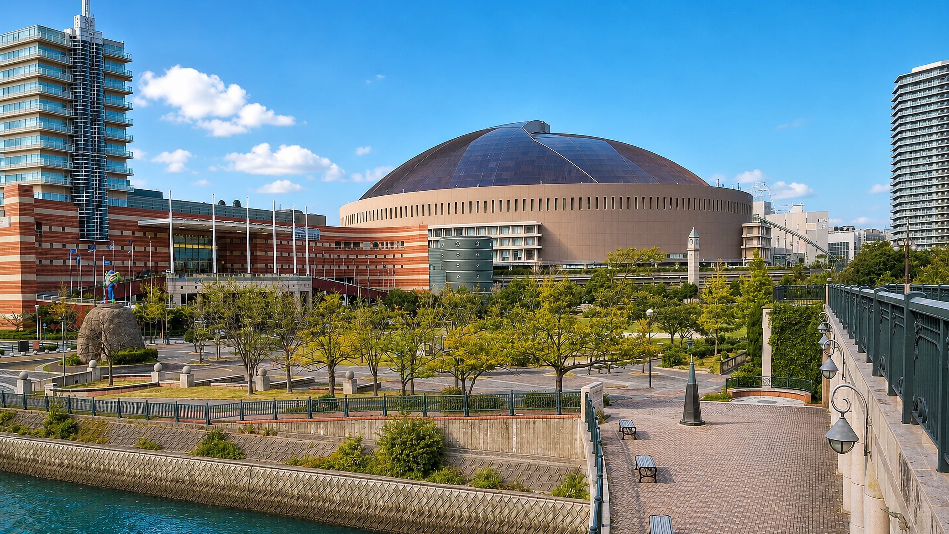 The domed stadium and waterfront promenade at Jigyohama in Fukuoka, seen across the canal on a clear day.