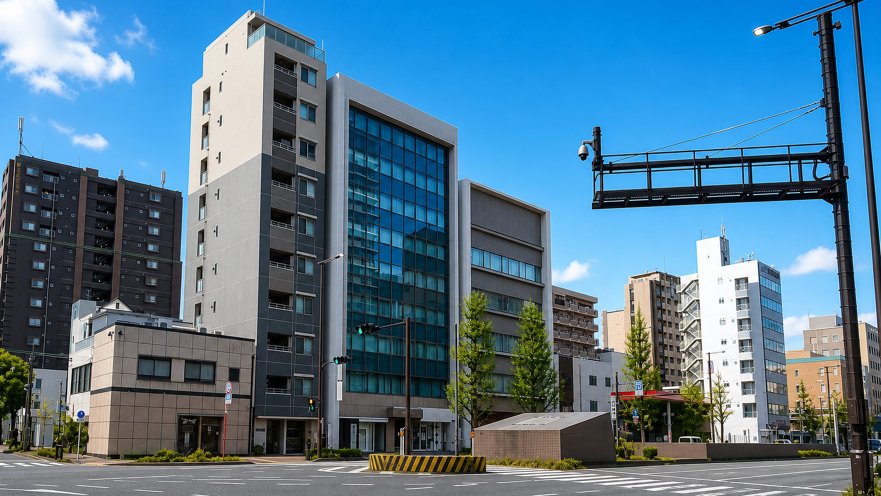 Wide crossing framed by mid-rise offices and apartments in Komondomachi, Fukuoka