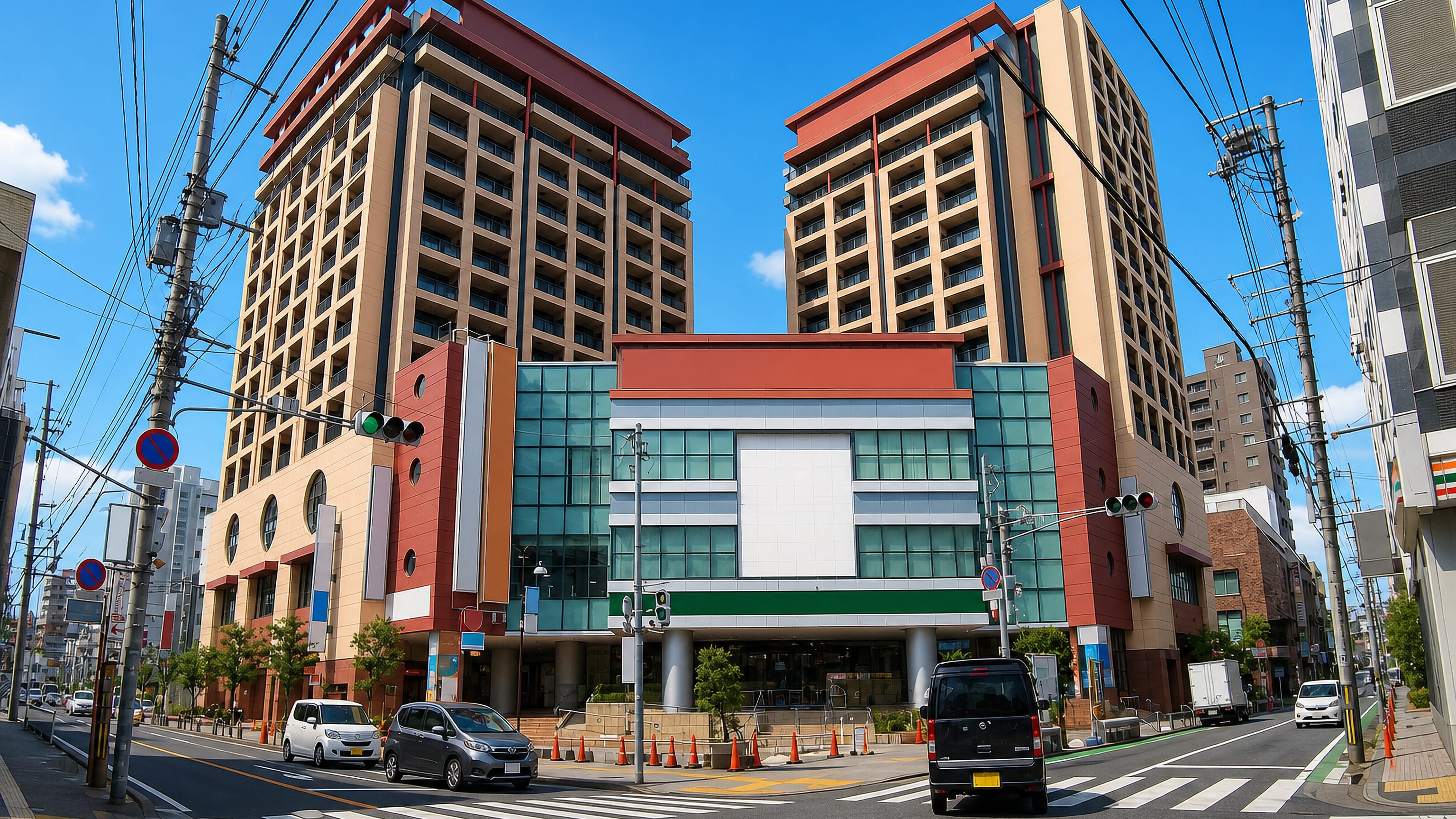 Twin residential towers above a glass-fronted commercial podium in Sohara, Fukuoka