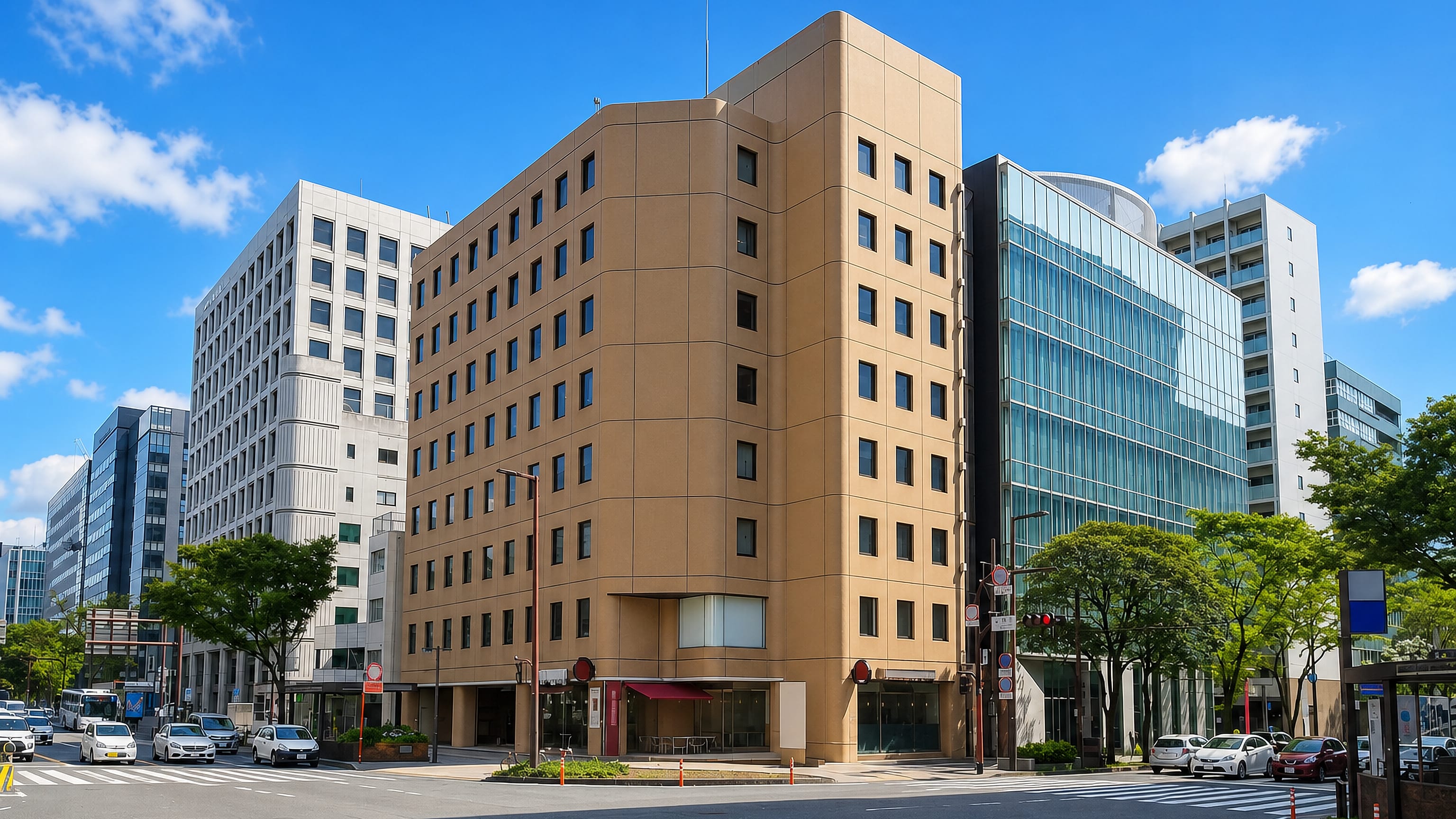Mid-rise offices and glass frontages at a wide street corner in Tenyamachi, Fukuoka.