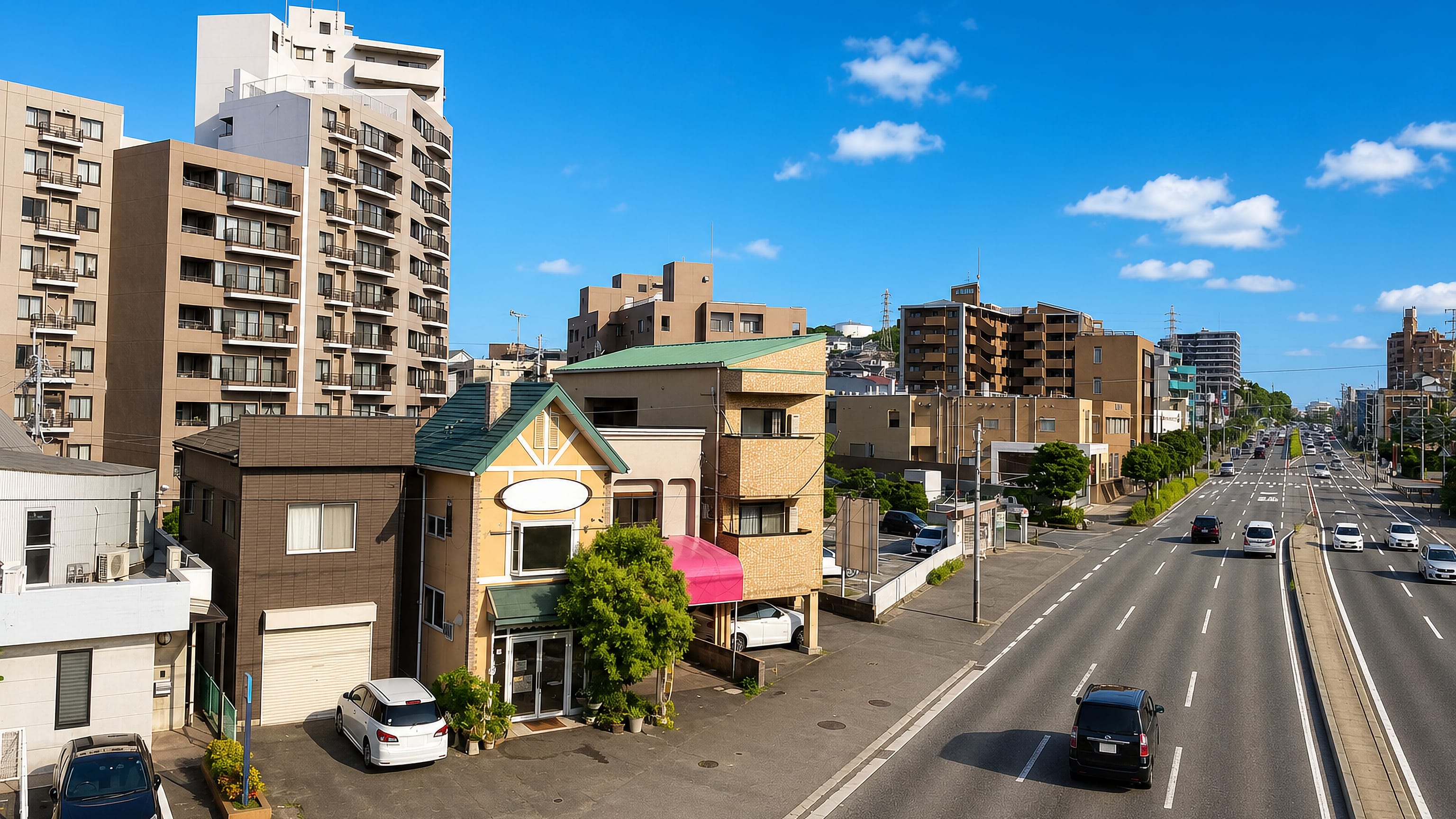 Apartment blocks and small shops beside a multi-lane road in Wakamiya, Fukuoka.