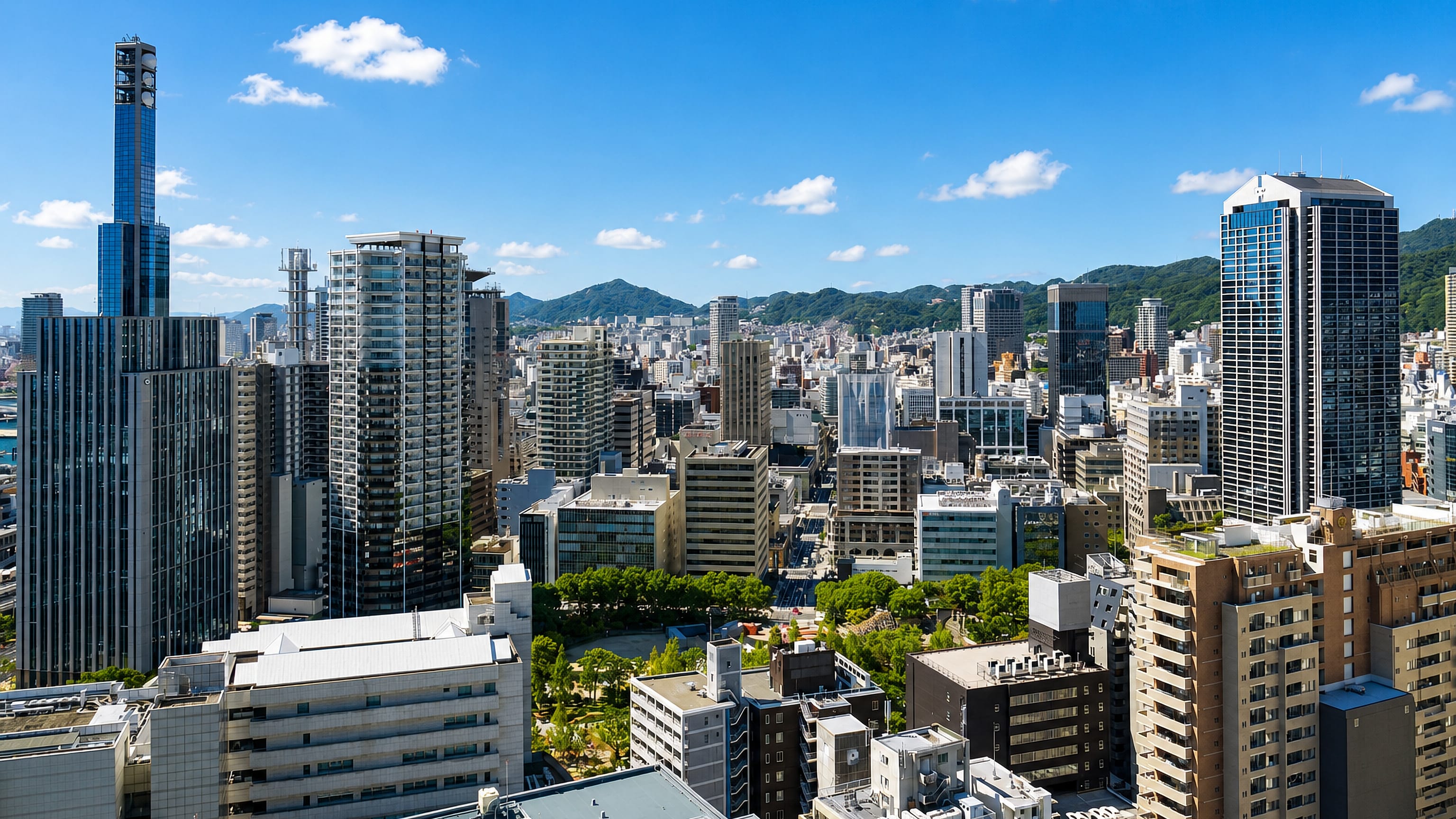 Sannomiya's high-rise skyline in central Kobe with the Rokko mountains rising behind