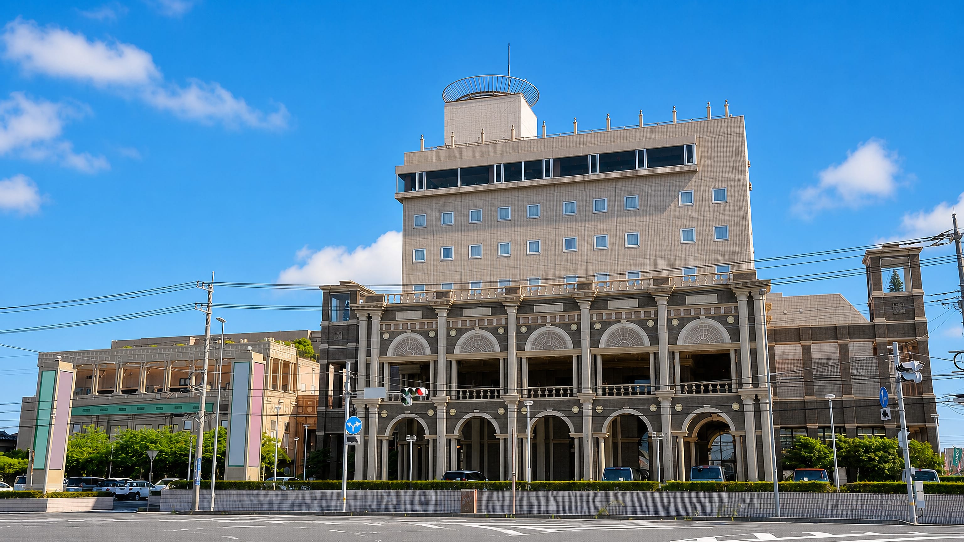 Arcaded civic building on a wide empty street corner in Kamisu, Ibaraki Prefecture, Japan.