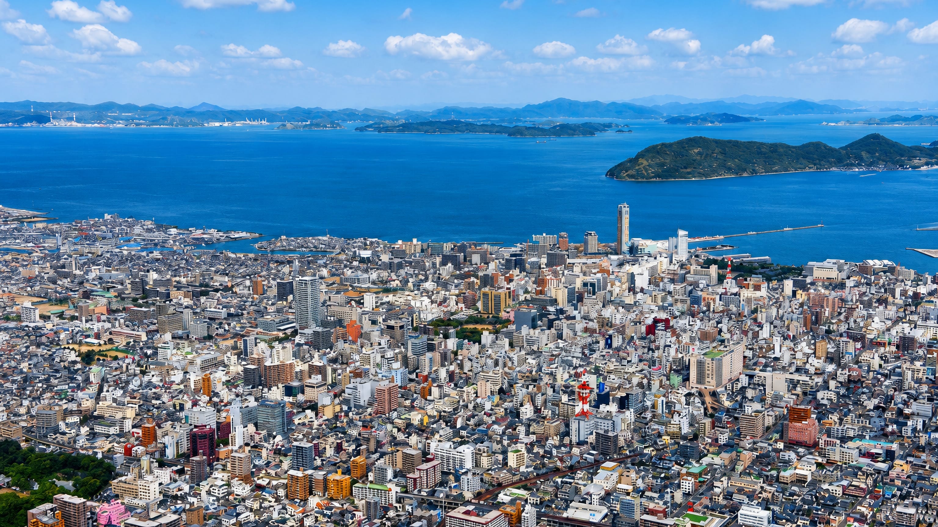 Takamatsu, Japan, seen from above: a dense downtown and port facing the island-dotted Seto Inland Sea.