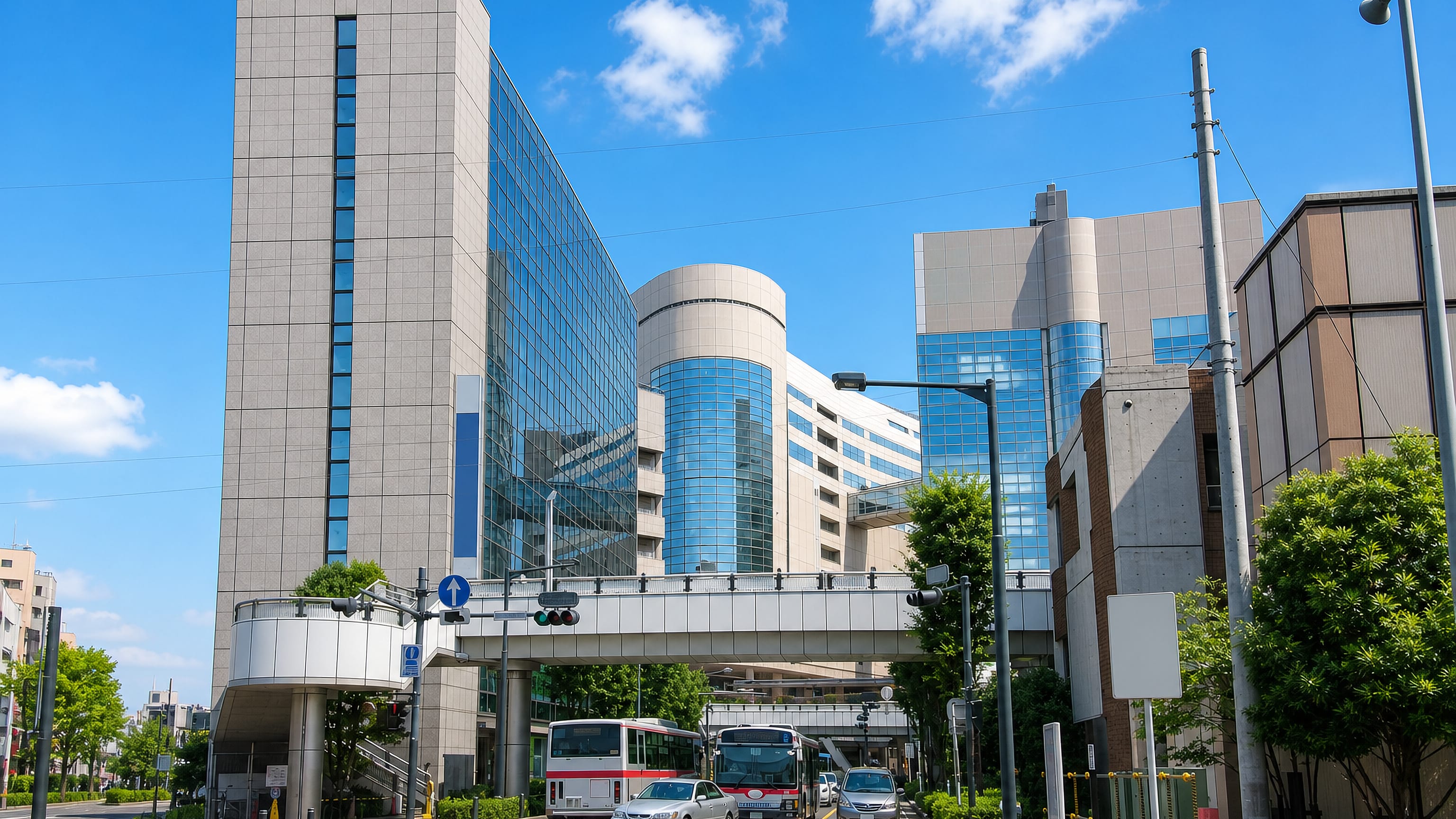 Pedestrian deck and station-front towers at Mizonokuchi in Kawasaki, with buses at the crossing.