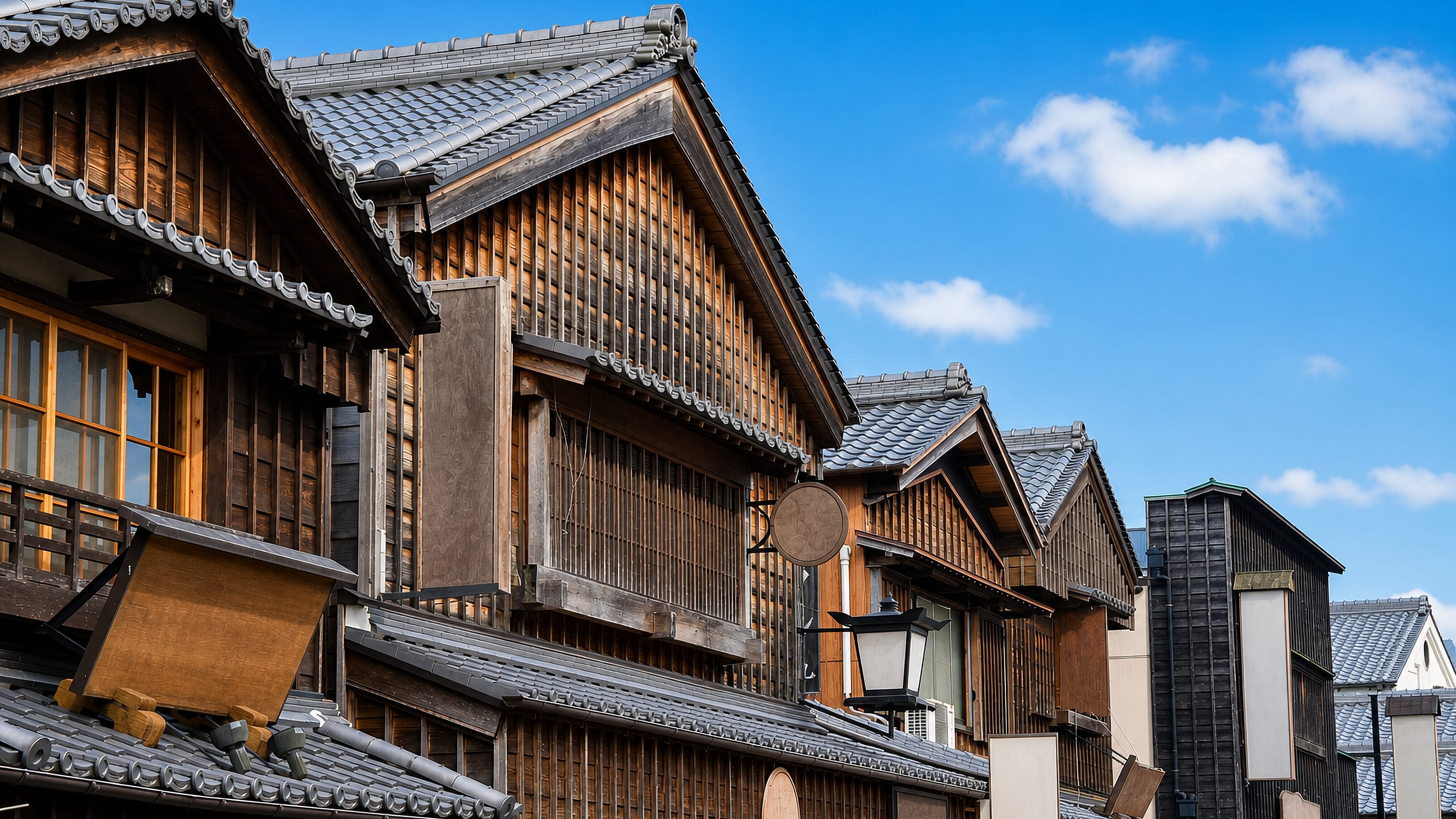 Traditional wooden merchant houses with tiled roofs along a street in Ise, Japan.