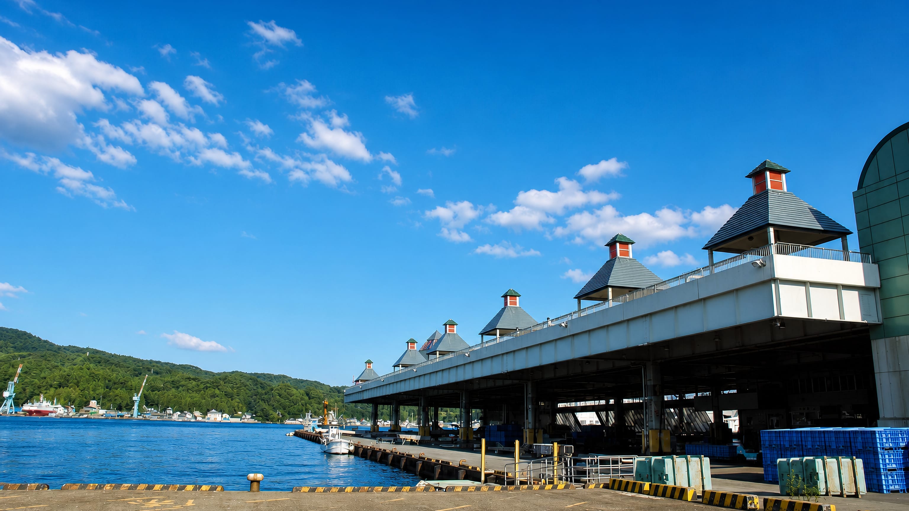 The covered quayside fish market and moored boats at the fishing port of Kesennuma, Miyagi, Japan