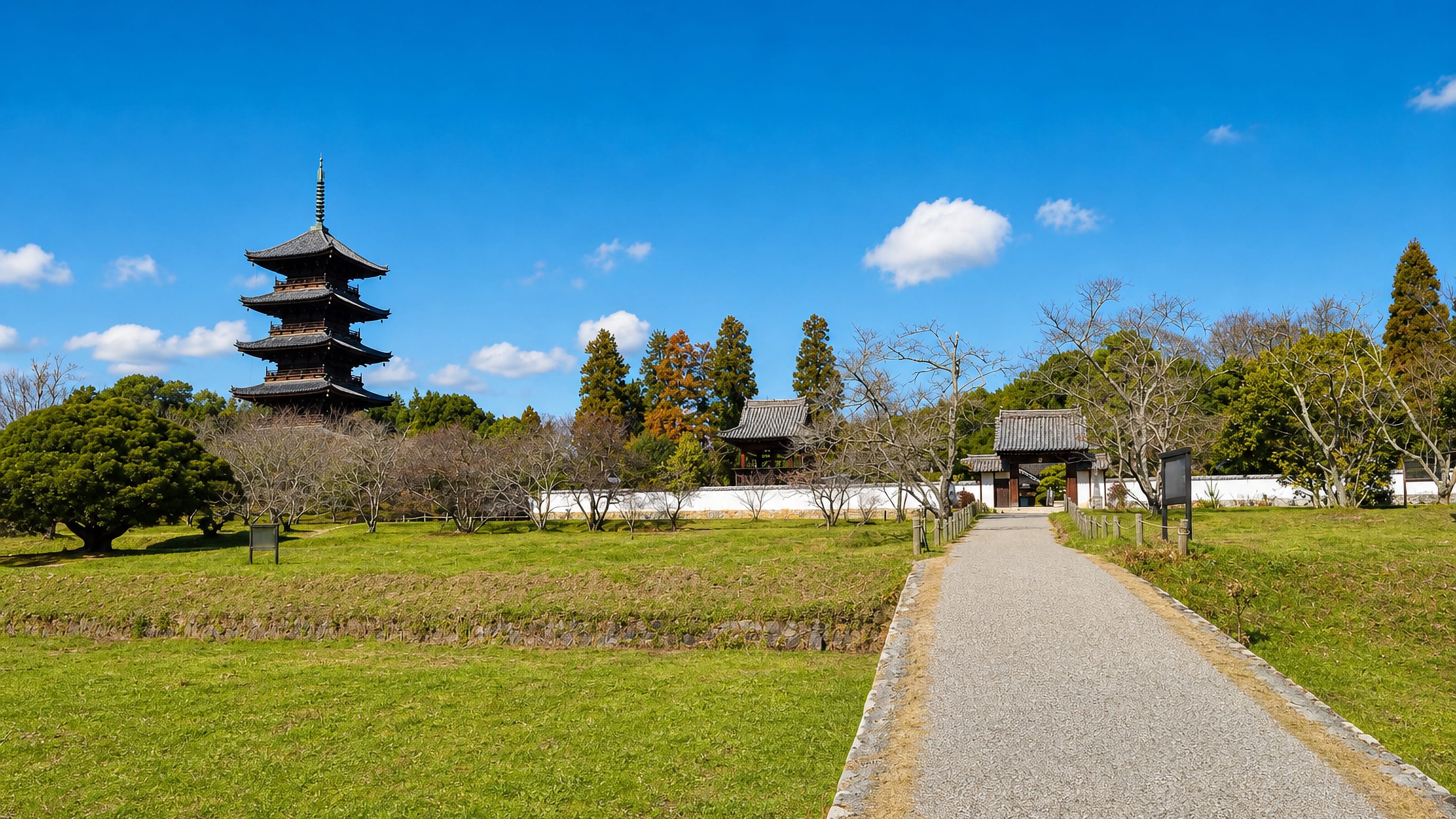 The five-storey pagoda of Bitchū Kokubun-ji rising over temple walls and open fields in Sōja, Okayama.
