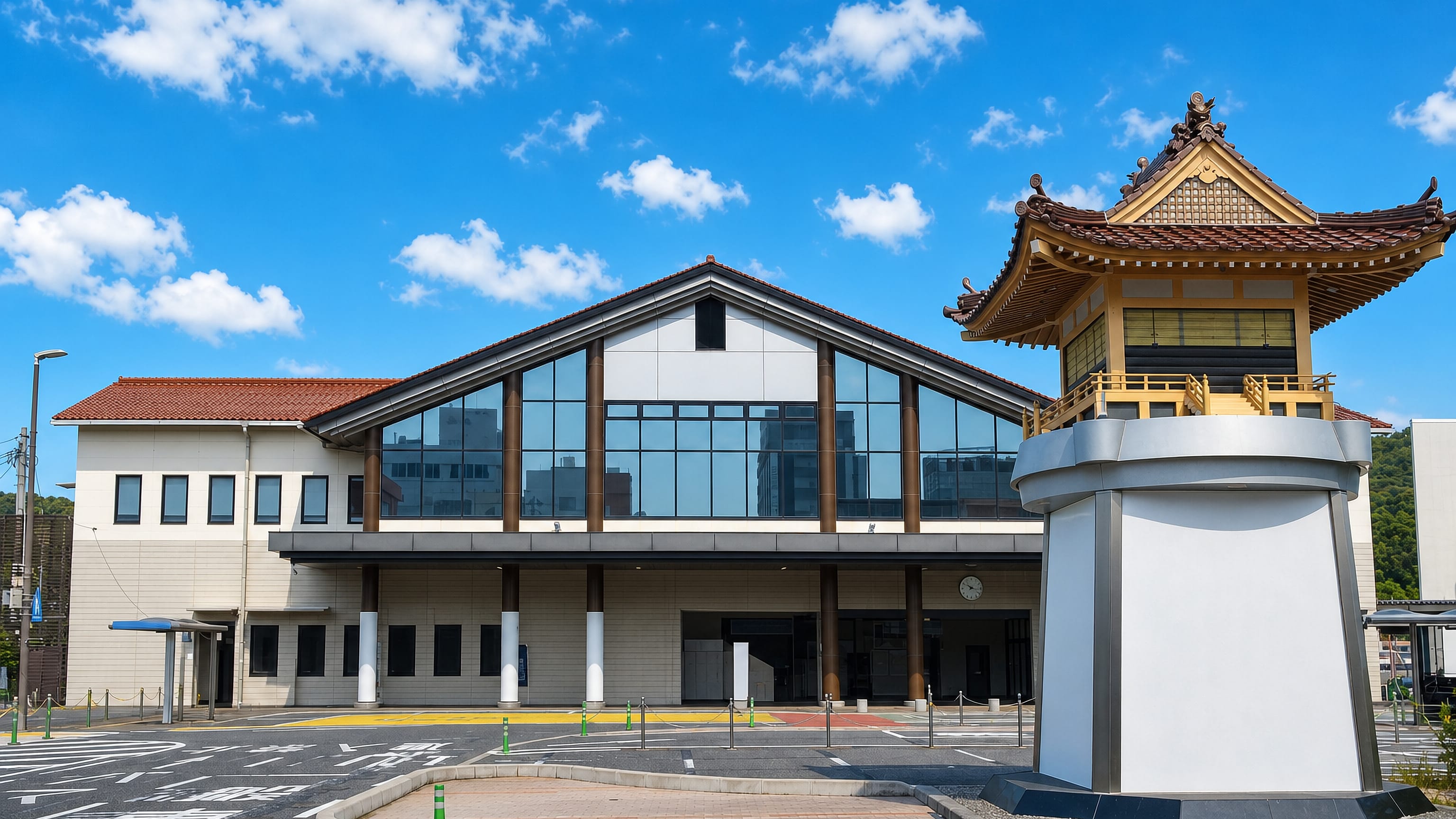 Hamada's modern station building with a gilded pagoda-style tower beside its empty forecourt in Shimane.
