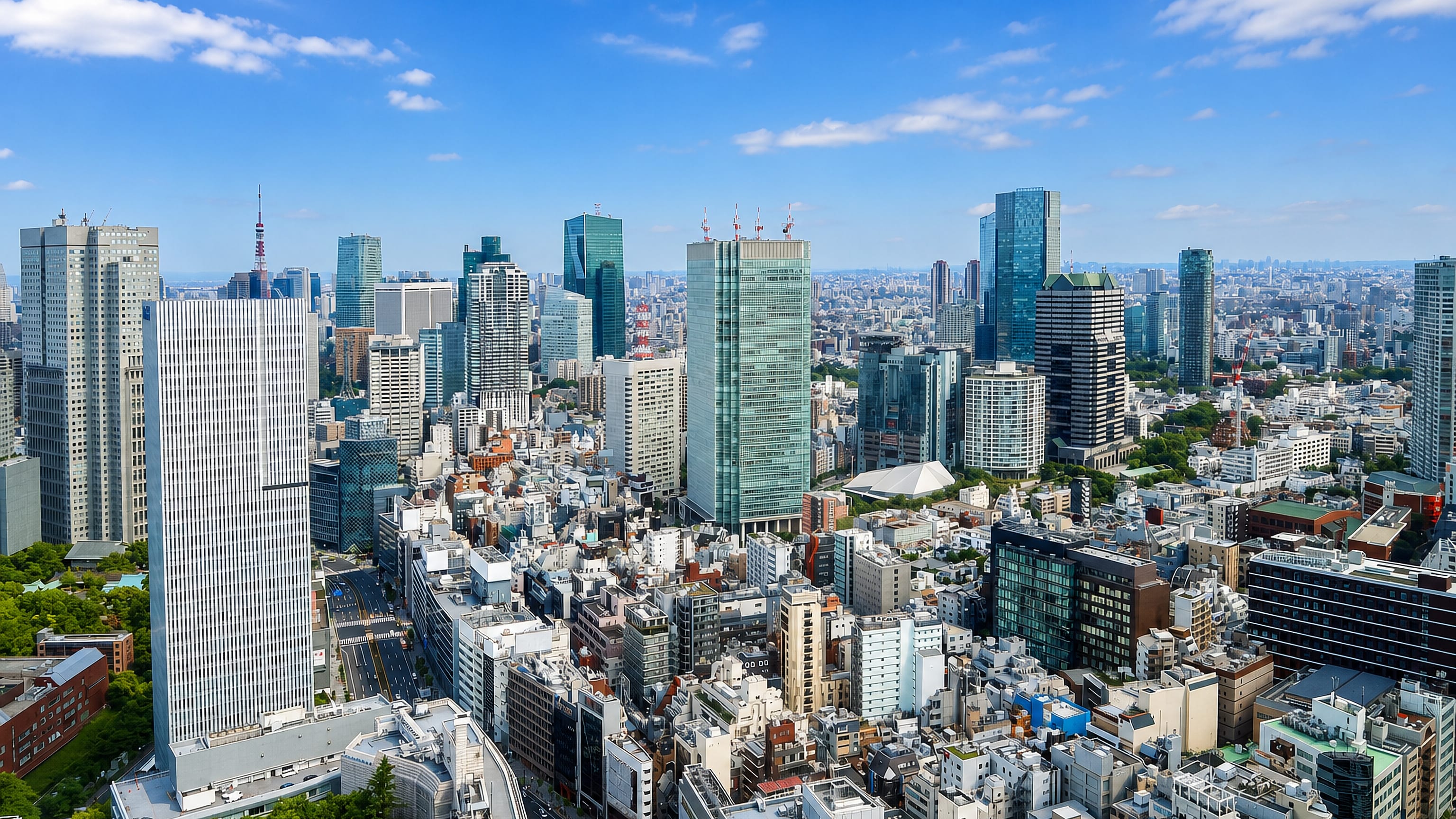 High-rise towers of Akasaka in Minato City, Tokyo, with Tokyo Tower on the skyline under clear blue sky