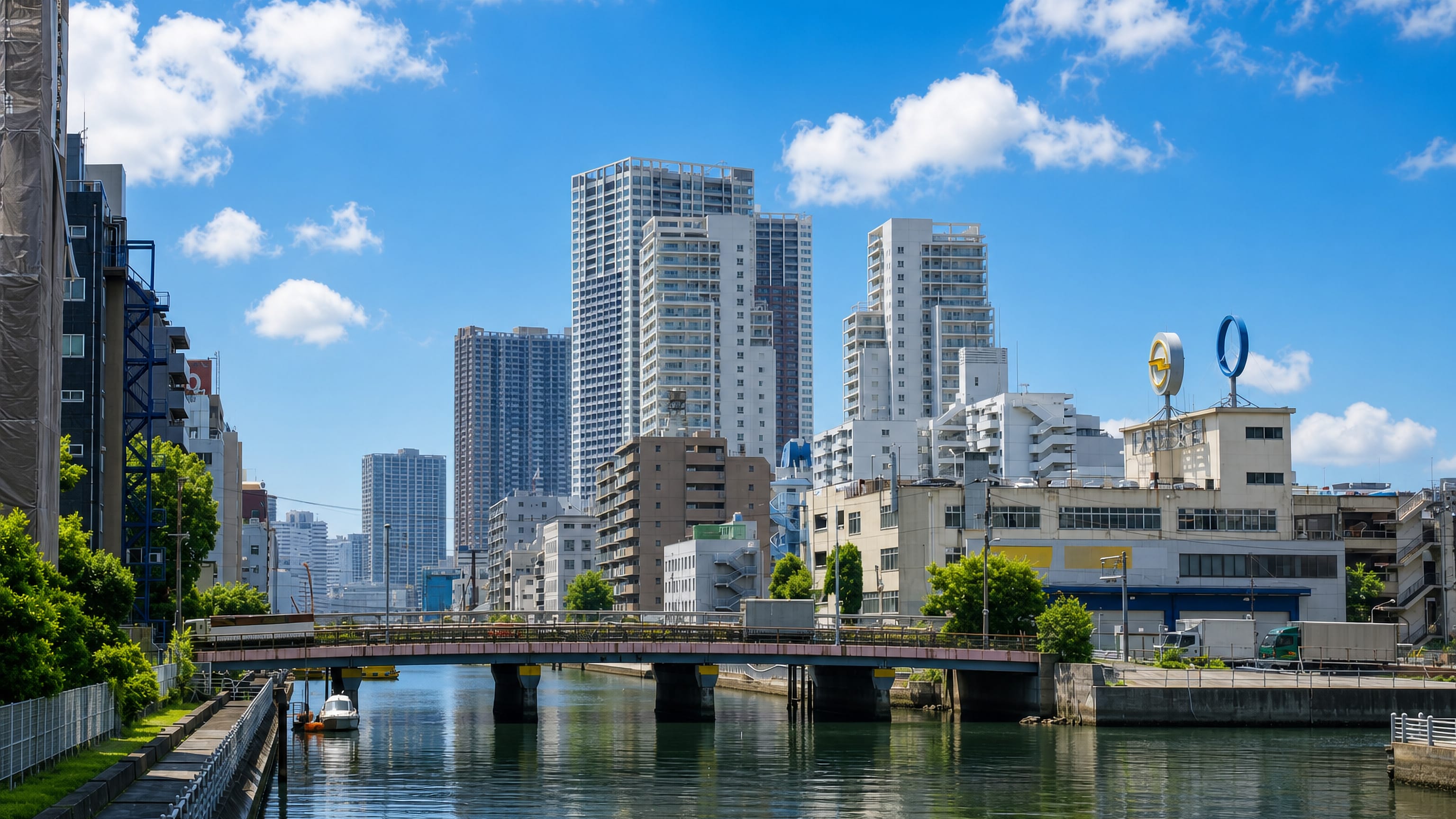 Canal bridge below waterfront high-rises and warehouses in Kaigan, Minato City, Tokyo.