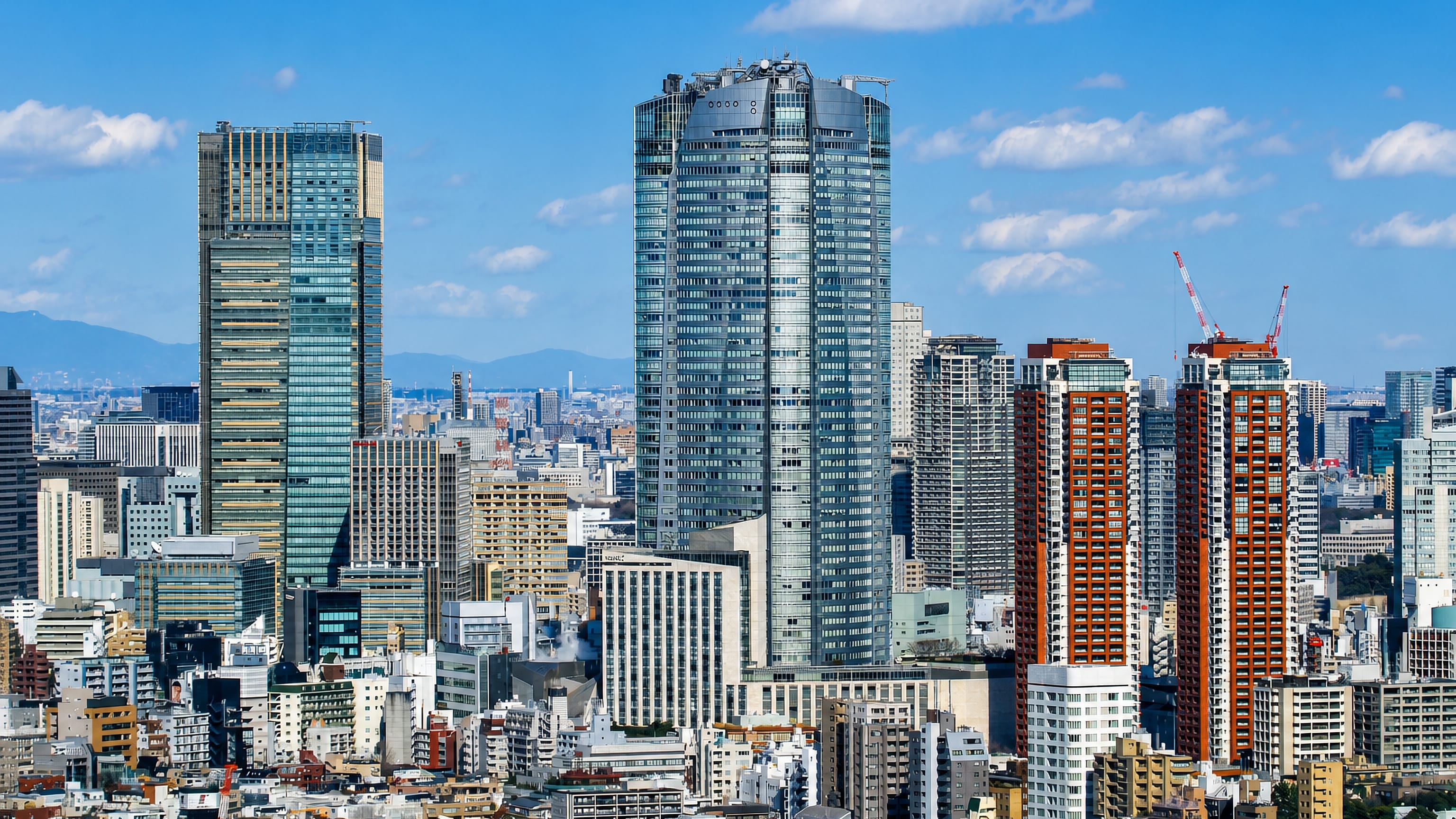 Roppongi's high-rise cluster in Tokyo, with Mori Tower and Midtown above dense Minato City rooftops.