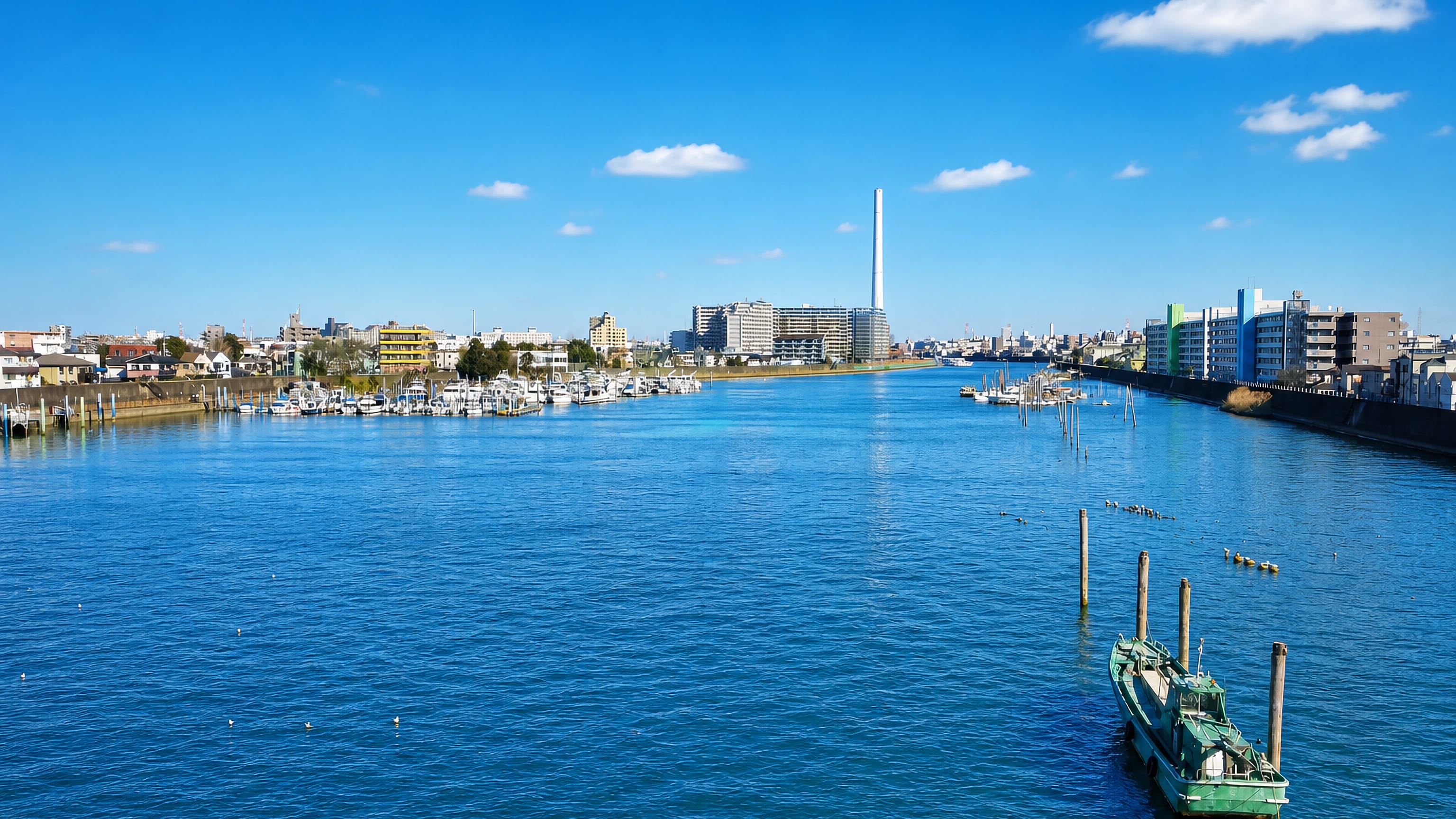 The Edogawa river in Tokyo's Edogawa ward, with moored boats, a marina and low-rise waterfront blocks.