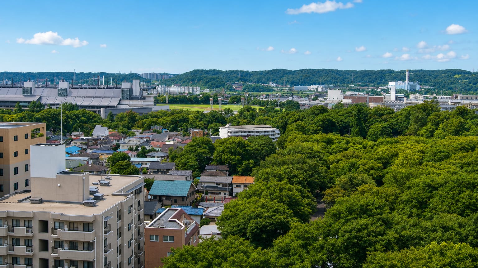 Elevated view over low-rise houses and leafy green streets of suburban Fuchū, western Tokyo.
