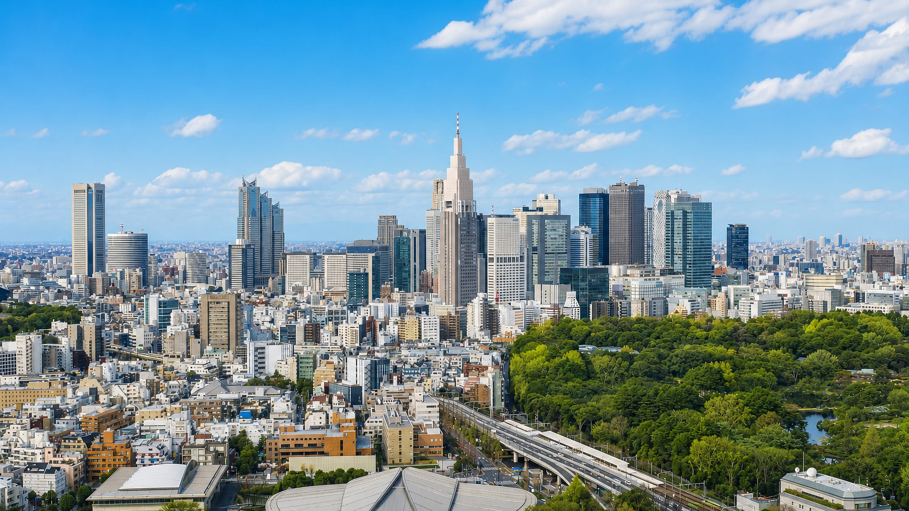 Sendagaya in Tokyo with the Metropolitan Gymnasium, Meiji Jingu greenery and the Shinjuku skyline beyond.